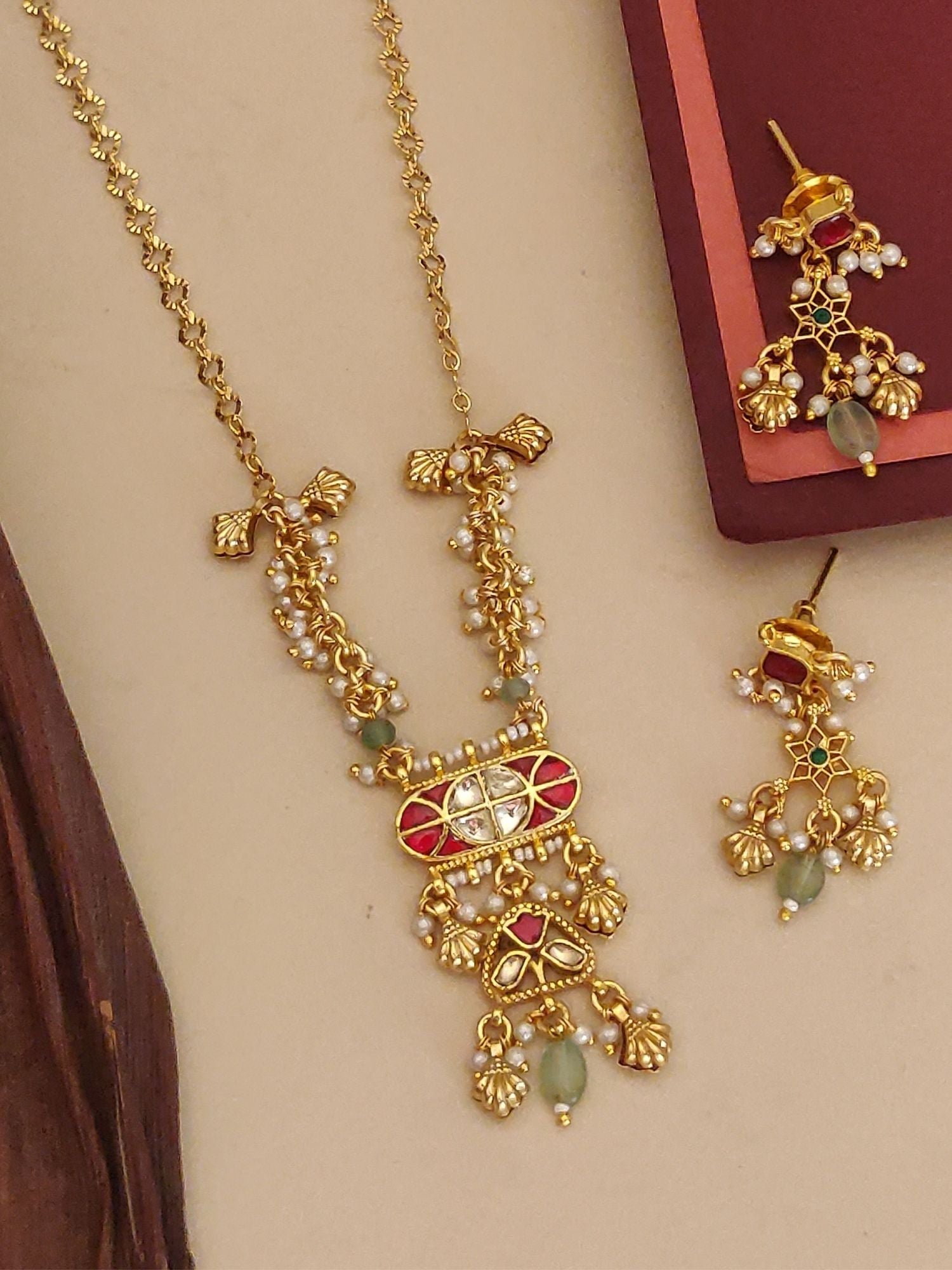Abdesigns Jewellery Pendents with Pearl and Red Stone Design. Gold necklace and matching earrings with green beads.