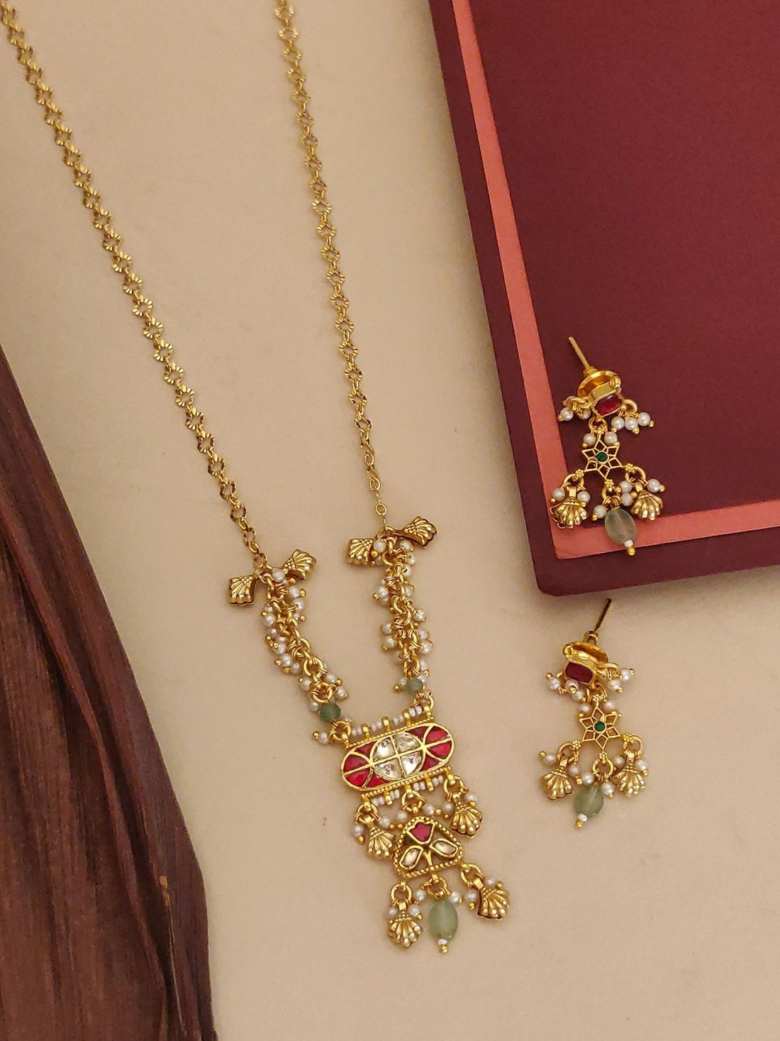 Abdesigns Jewellery Pendents with Pearl and Red Stone Design. Gold plated necklace and earrings with pearls and red stones