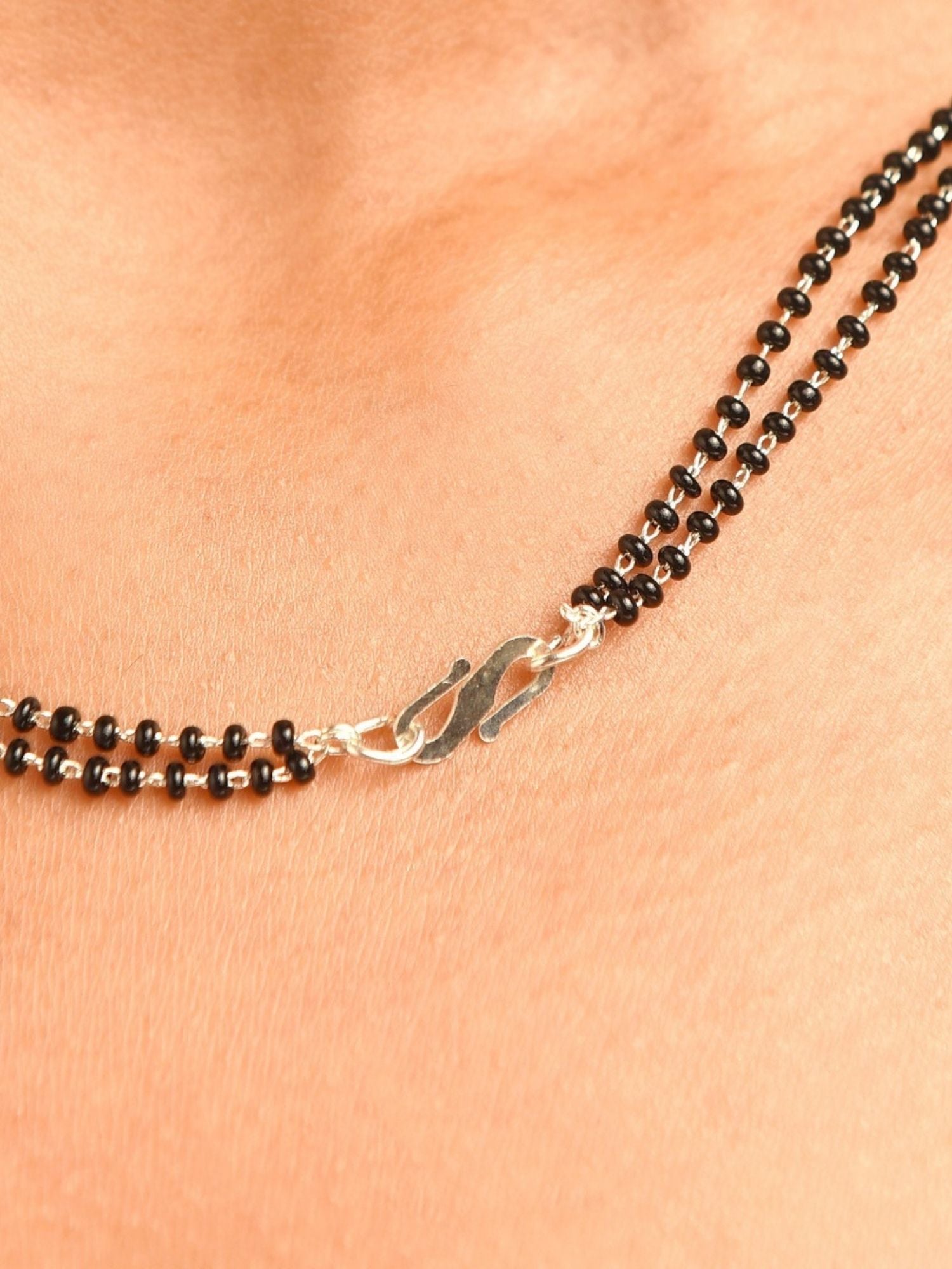 Abdesigns Jewellery Silver Plated American Diamond Mangalsutra With Earrings. close up black bead chain silver clasp on neck