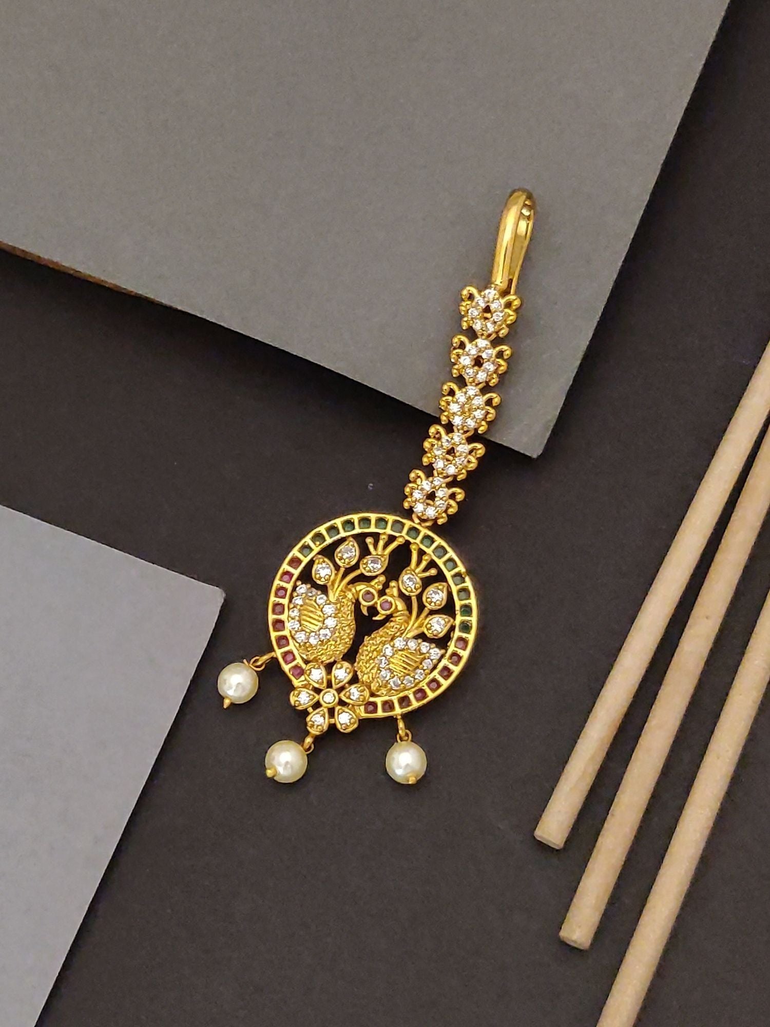 Abdesigns peacock design maangtikka for Women. Gold plated peacock maangtikka with pearl drops and stone detailing