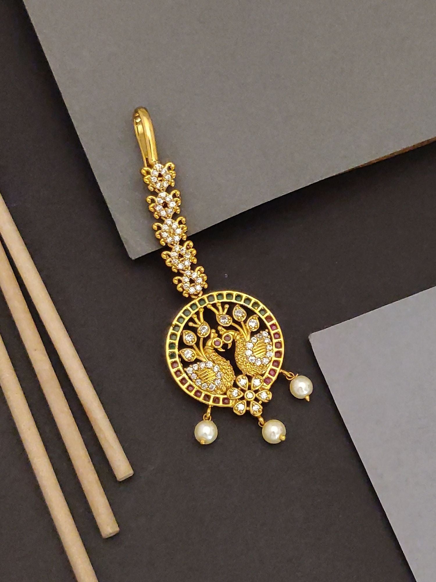 Abdesigns peacock design maangtikka for Women. Gold plated circular maangtikka with peacock motif, crystals and pearl drops