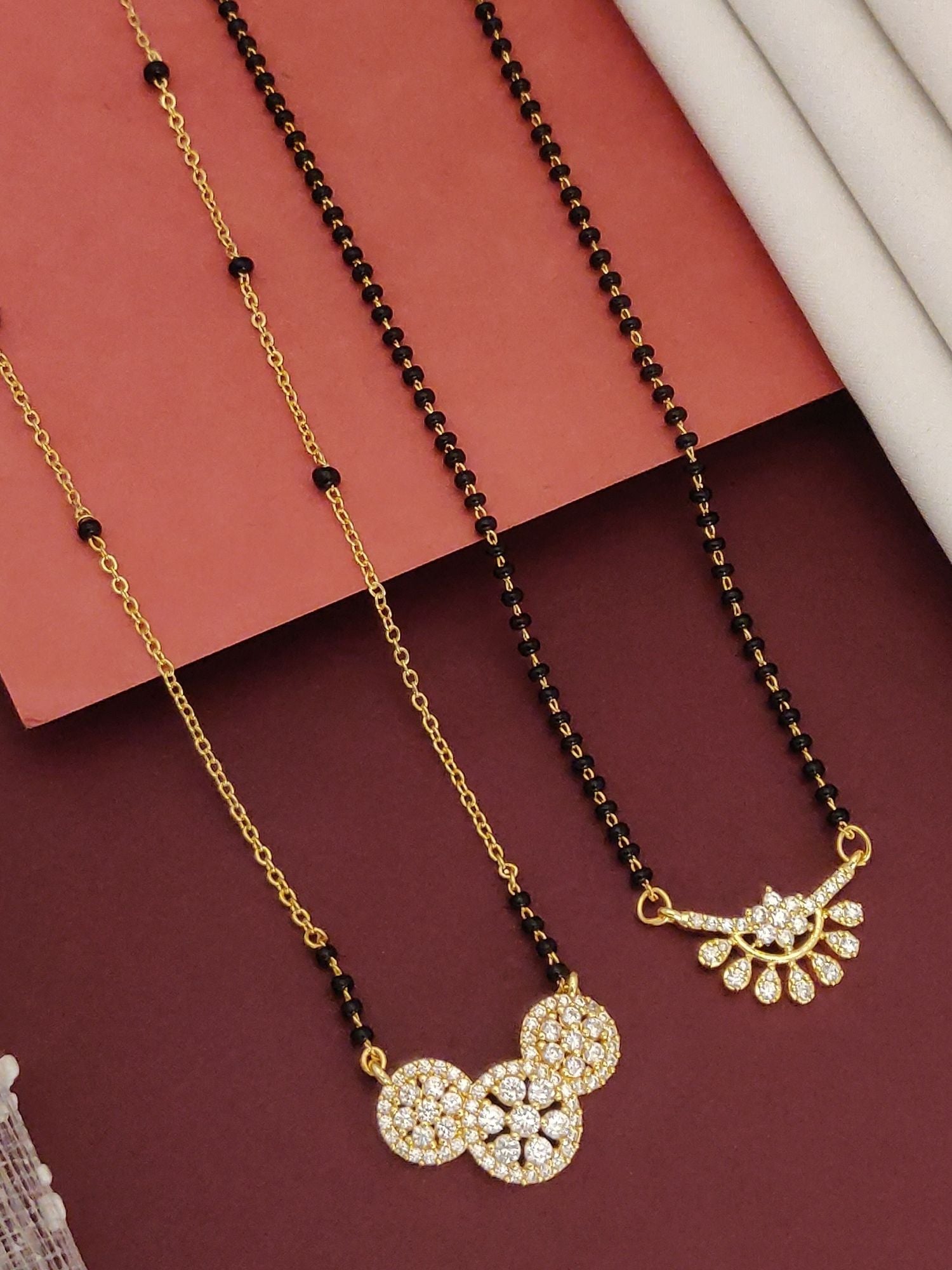 Abdesigns Precise Set of 2 gold plated mangalsutra combo for women. Two necklaces with black beads and stone pendants