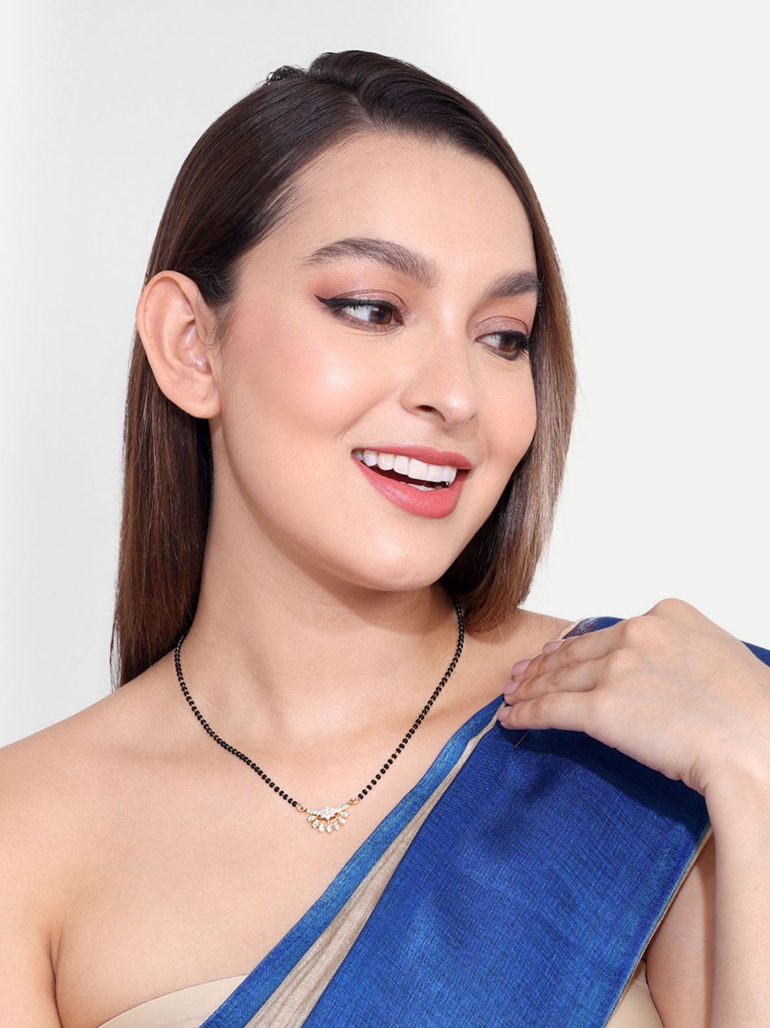 Abdesigns Precise Set of 2 gold plated mangalsutra combo for women. Woman wearing gold mangalsutra with black beads charm