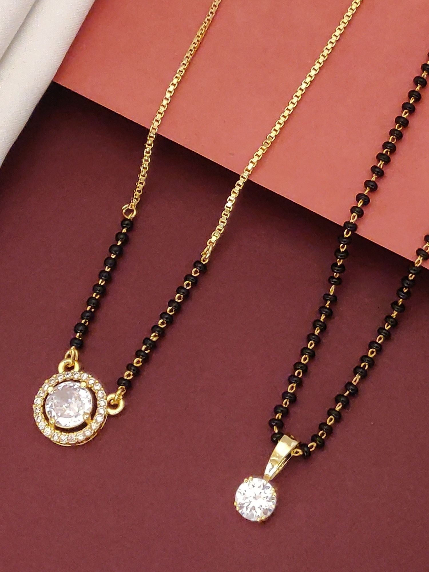 Abdesigns Regal Set of 2 gold plated mangalsutra combo for women. Two black bead chains with gold plated CZ pendants