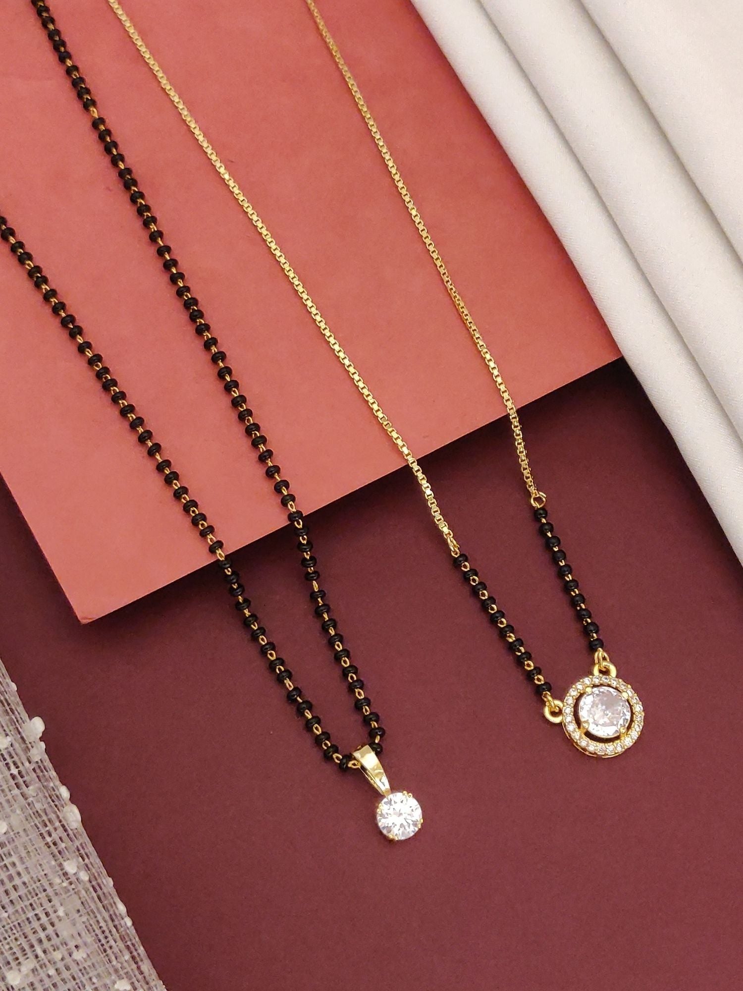 Abdesigns Regal Set of 2 gold plated mangalsutra combo for women. Two gold chains with black beads and round cz pendants