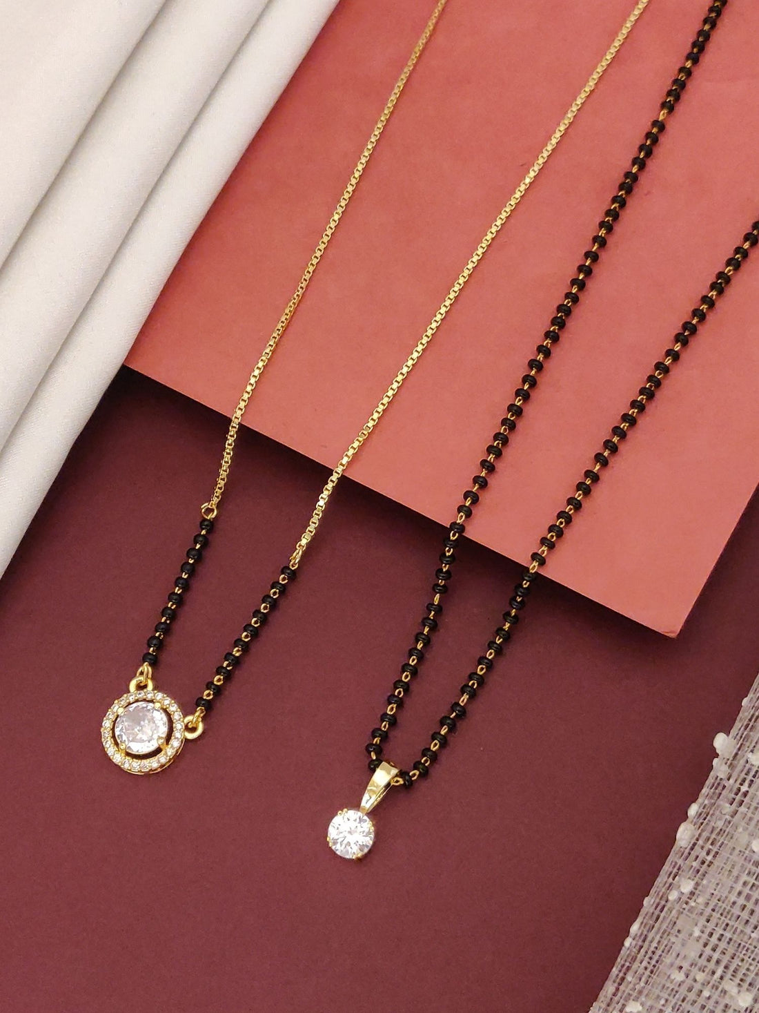 Abdesigns Regal Set of 2 gold plated mangalsutra combo for women. Two gold chains with black beads and round cz pendants