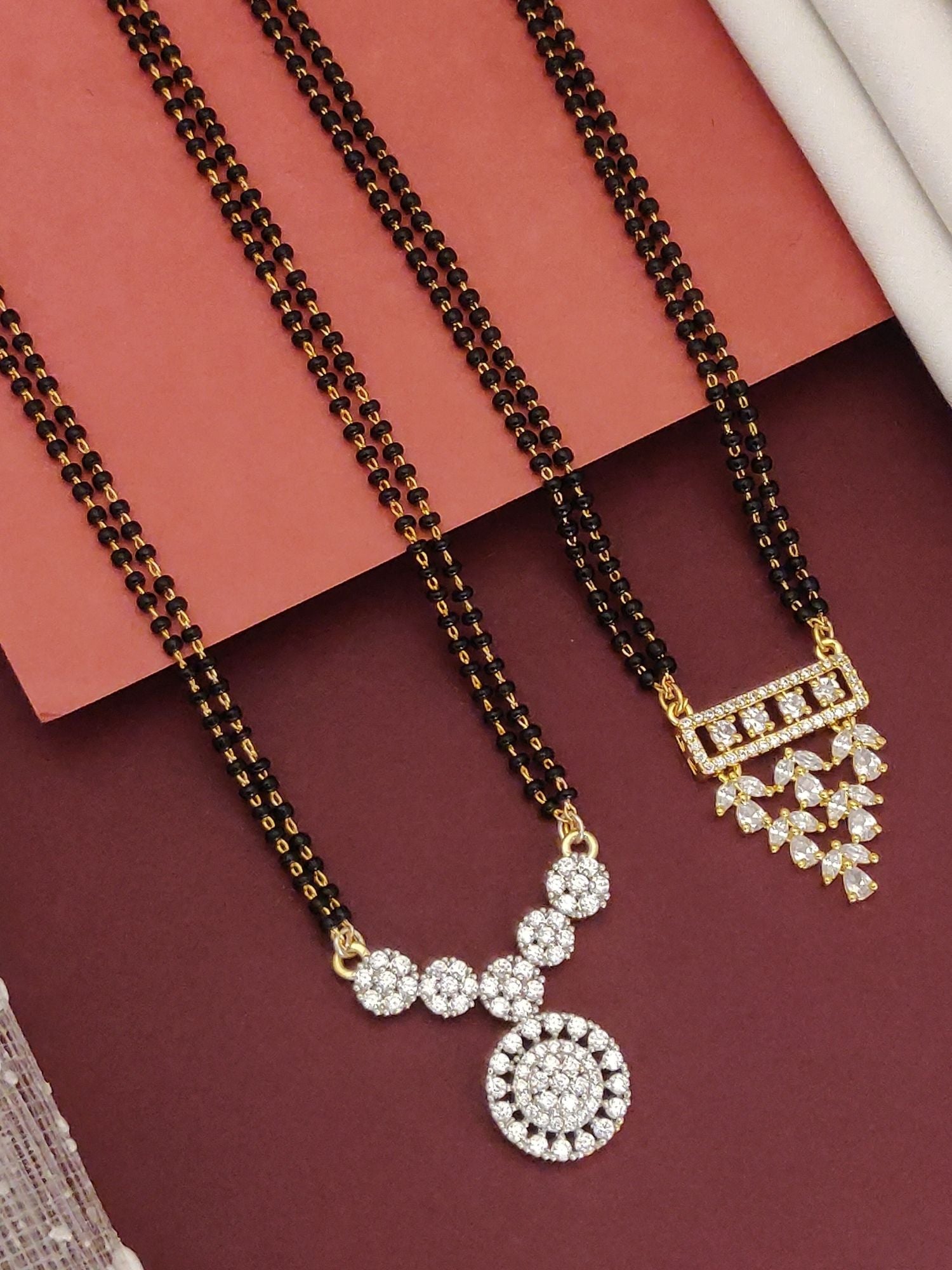 Abdesigns Set of 2 Detailed gold plated mangalsutra combo for women. Two black bead chains with gold and crystal pendants