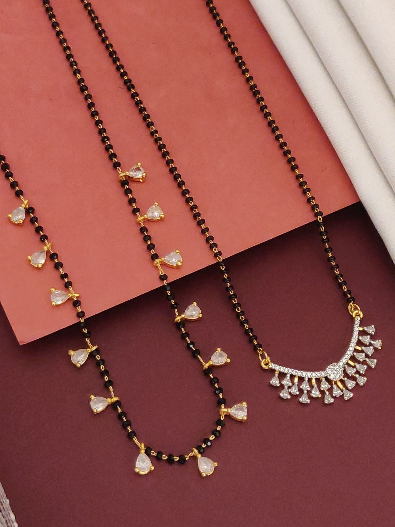 Abdesigns Set of 2 gold plated mangalsutra combo for women. Two black bead necklaces with gold and crystal pendants