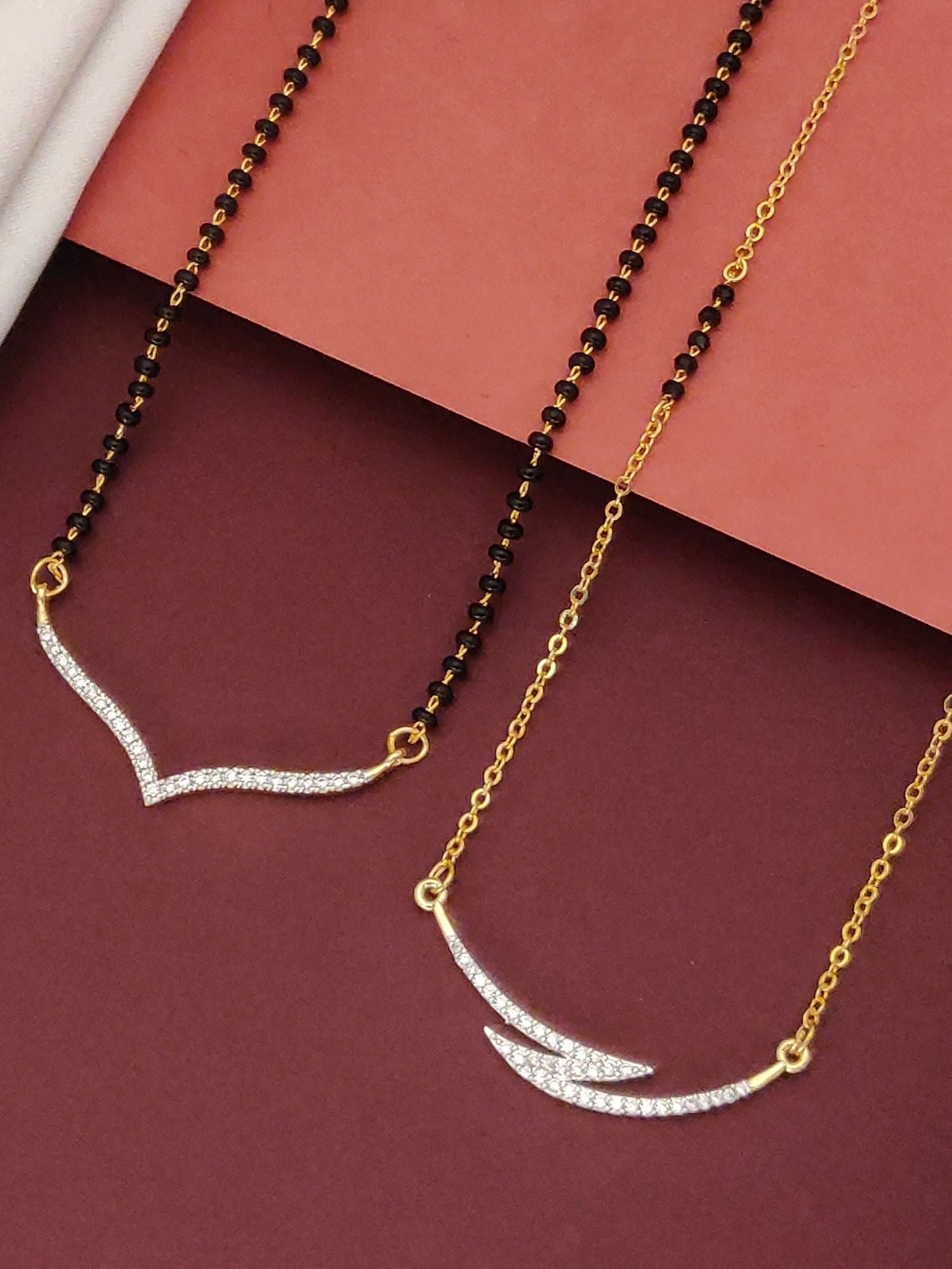 Abdesigns Set of 2 gold plated mangalsutra combo for women. Two slim mangalsutras with black beads and jeweled V pendants