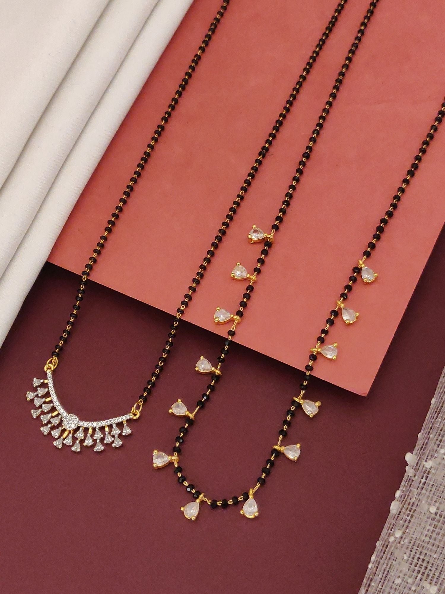 Abdesigns Set of 2 gold plated mangalsutra combo for women. Black beaded mangalsutras with crystal hearts and crescent pendant