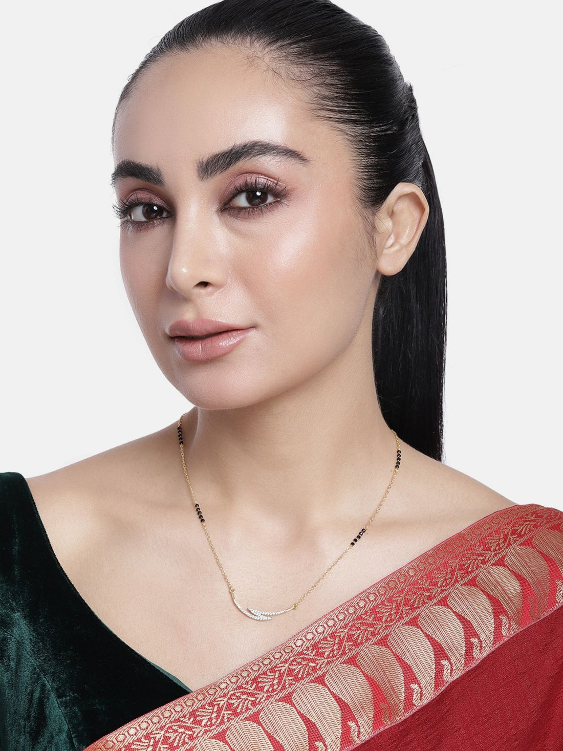 Model wearing Abdesigns Set of 2 gold plated mangalsutra combo for women. Two delicate black bead chains with V shaped gold pendant