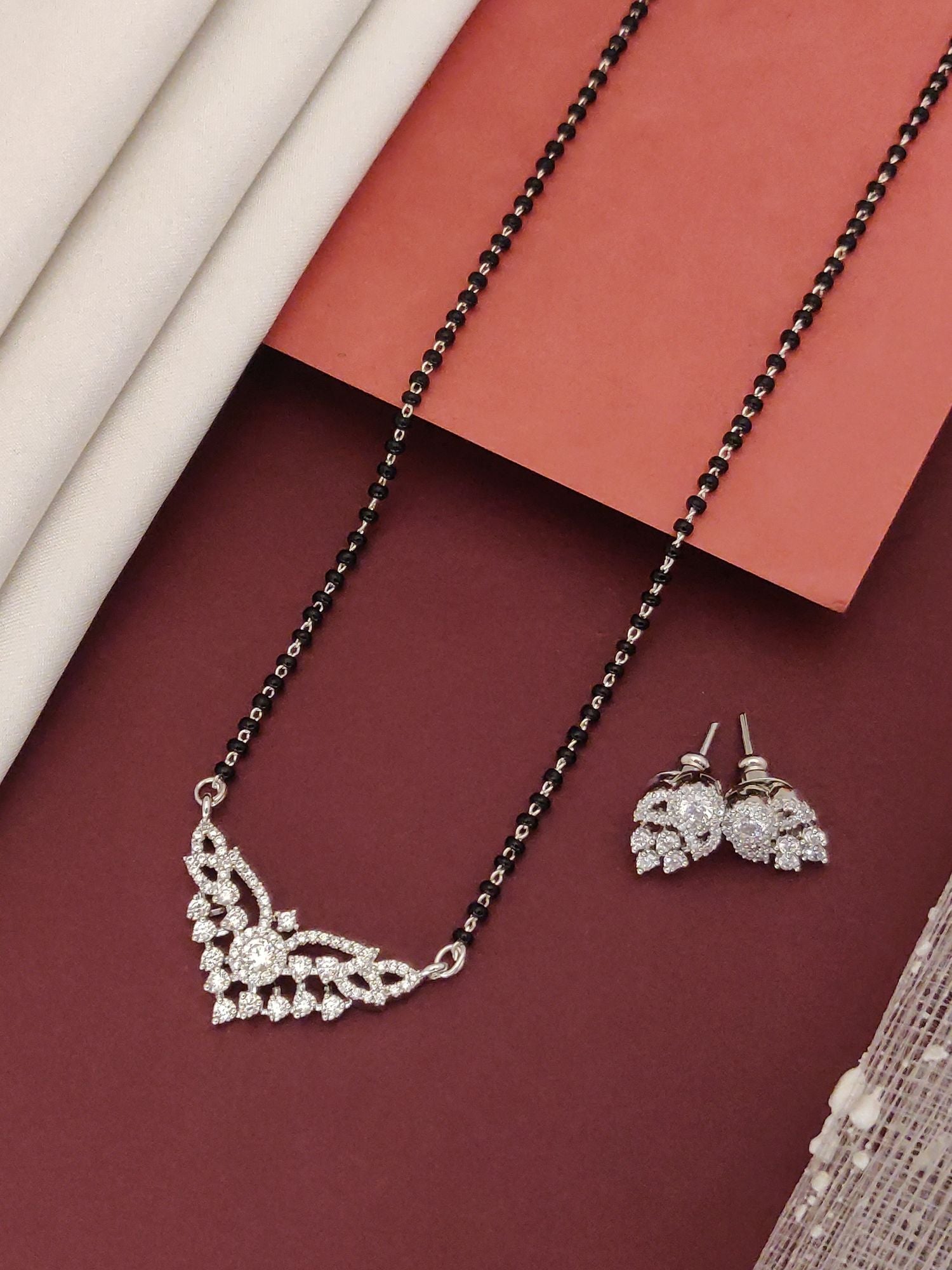 Abdesigns Sparkling CZ Mangalsutra Set black beaded chain with cubic zirconia pendant and matching stud earrings for bridal wear