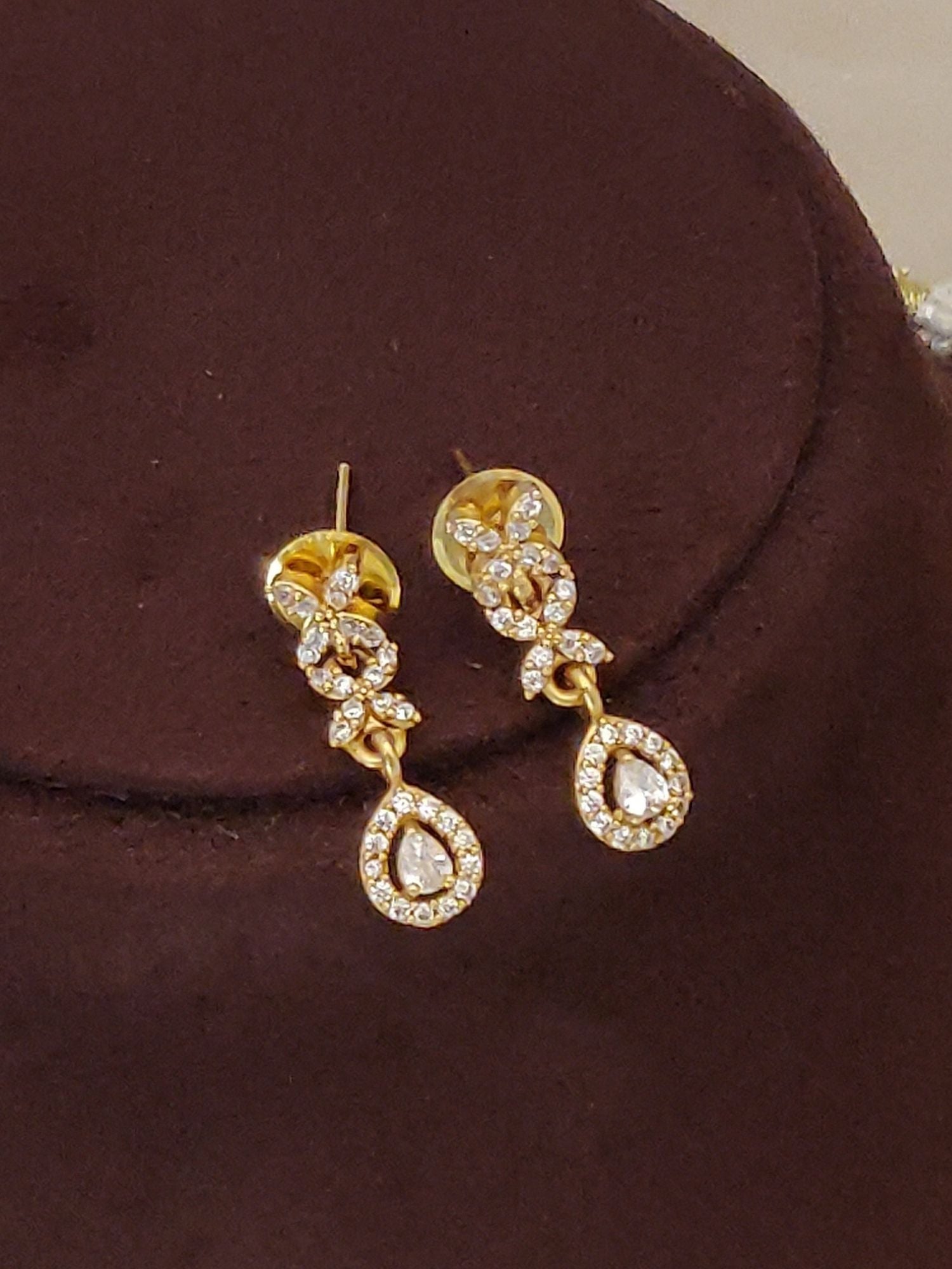 Abdesignsjewellery artificial diamond necklace with earrings product image showing gold teardrop earrings on brown background