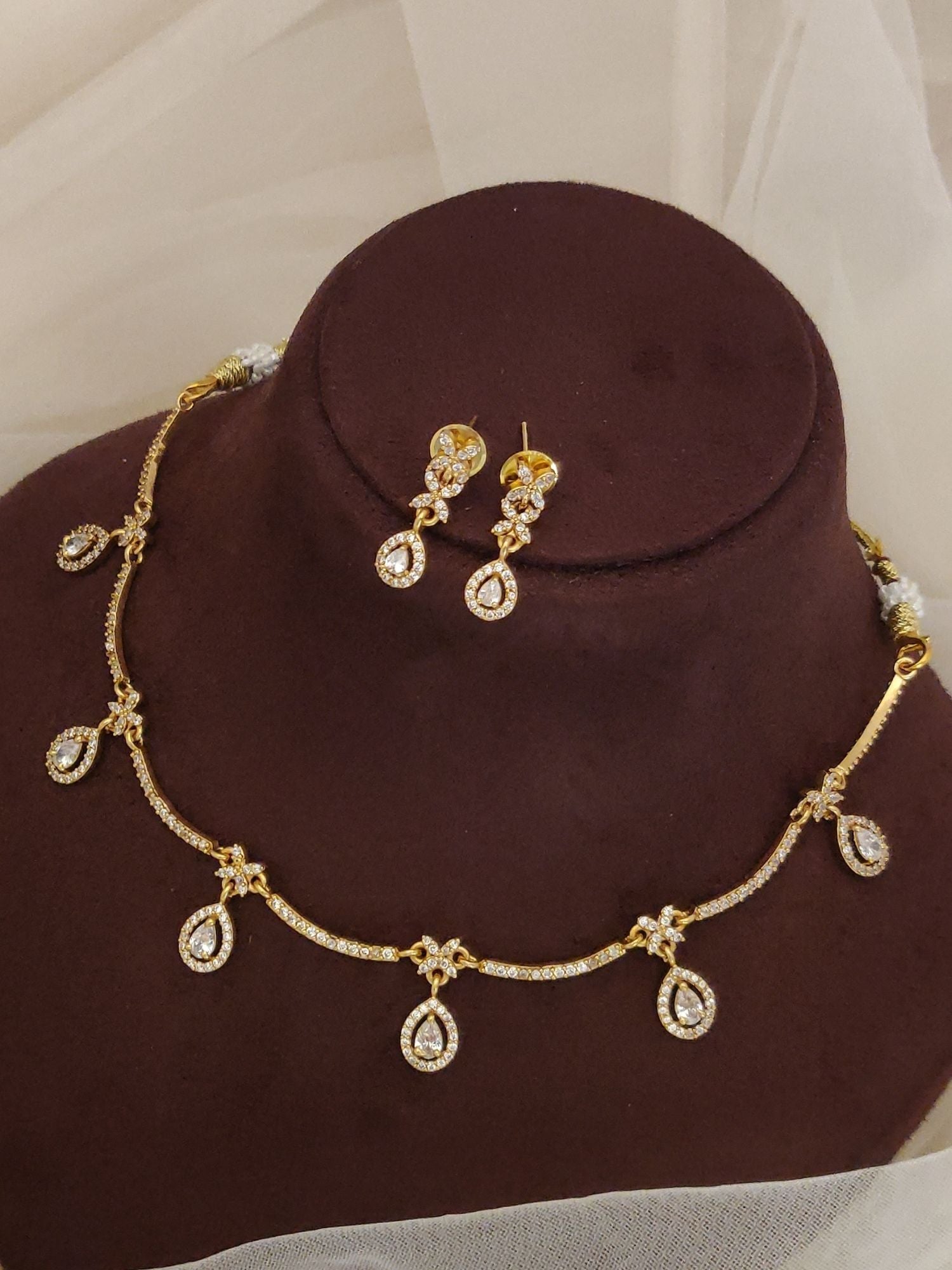 Abdesignsjewellery gold teardrop pendant and chain artificial diamond necklace with earrings set on brown display
