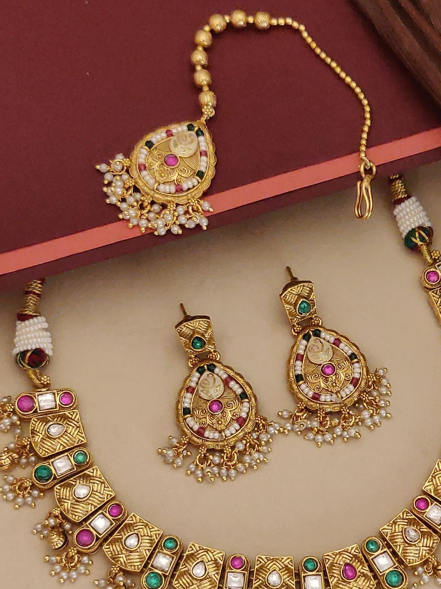 Abdesignsjewellery artificial gold maangtikka necklace earrings set with pink and green stones and pearl fringe