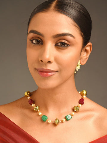 artificial multicolor bead necklace for women on model featuring green red and gold beads with pearl spacers