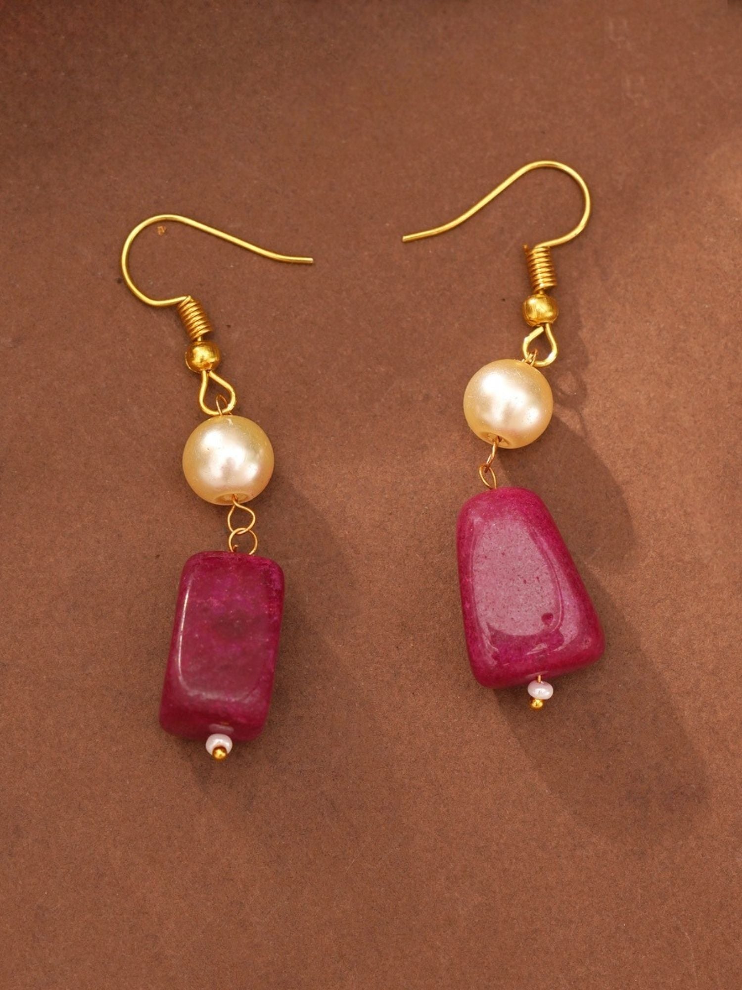 Gold hook earrings with faux pearl and magenta rectangular beads on brown background artificial multicolor bead necklace for women