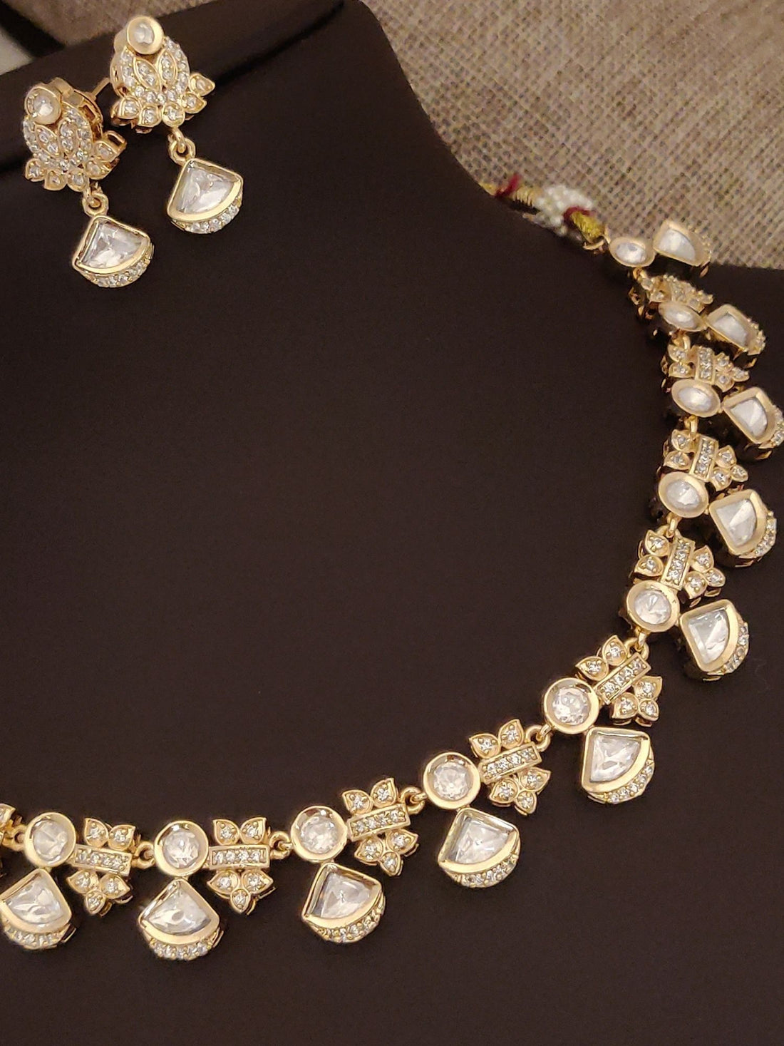 Elegant artificial polki necklace with earrings, featuring intricate gold design and shiny gems