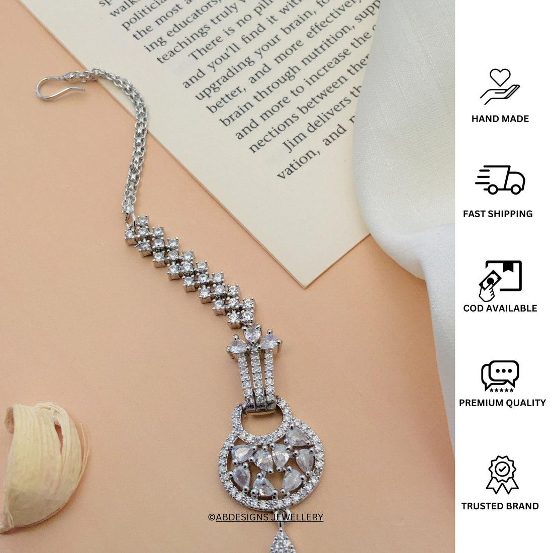 Beautiful Silver Plated American Diamond Maangtikka worn on forehead by woman with sleek hair
