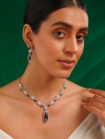 Blue Sapphire Silver Plated American Diamond Necklace Set worn by a woman with matching earrings
