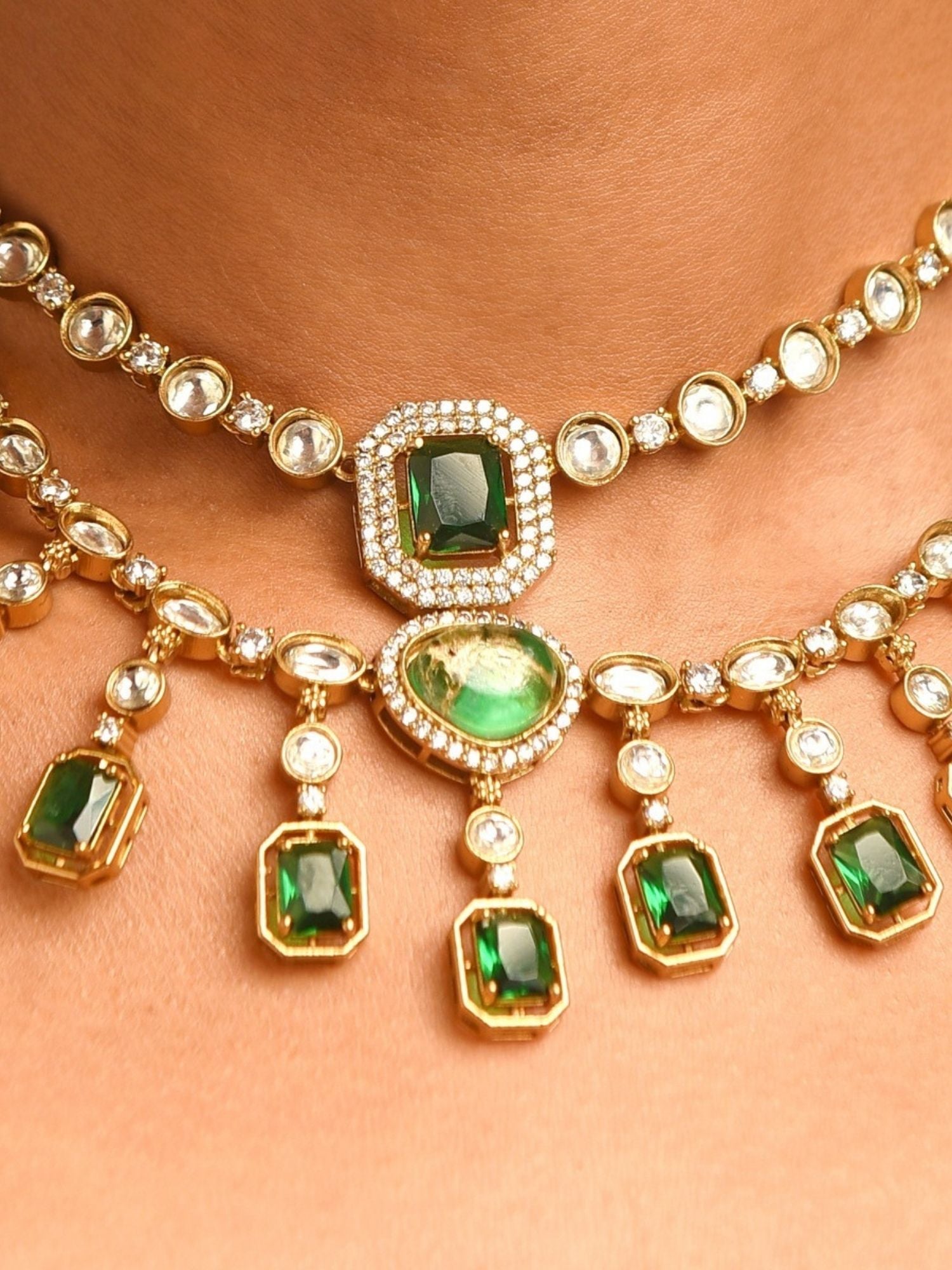 Close up of Abdesignsjewellery bridal polki necklace and earrings in gold with green stones and polki diamonds