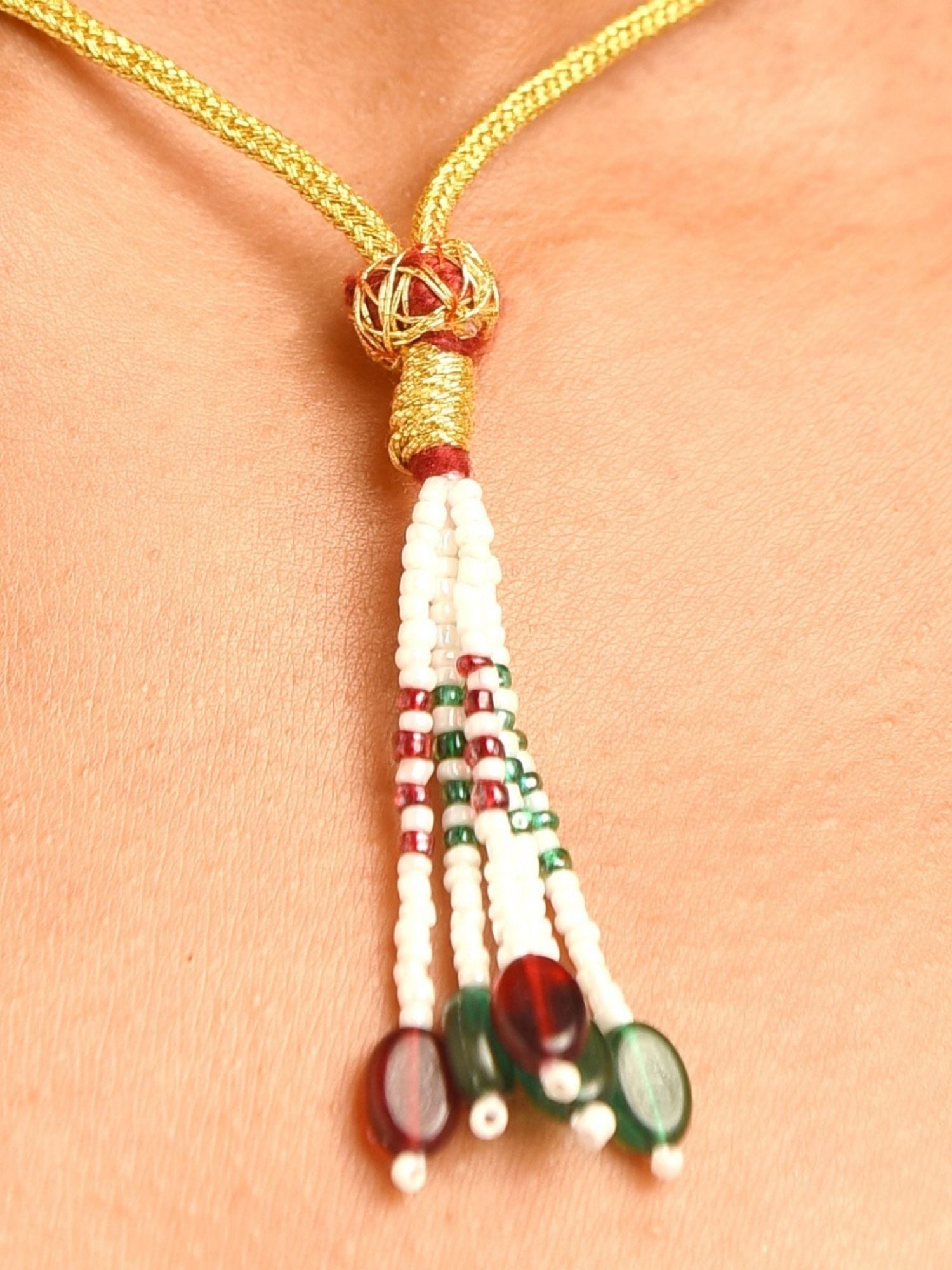 Abdesignsjewellery gold cord necklace with white seed bead tassel and red green beads bridal polki necklace and earrings