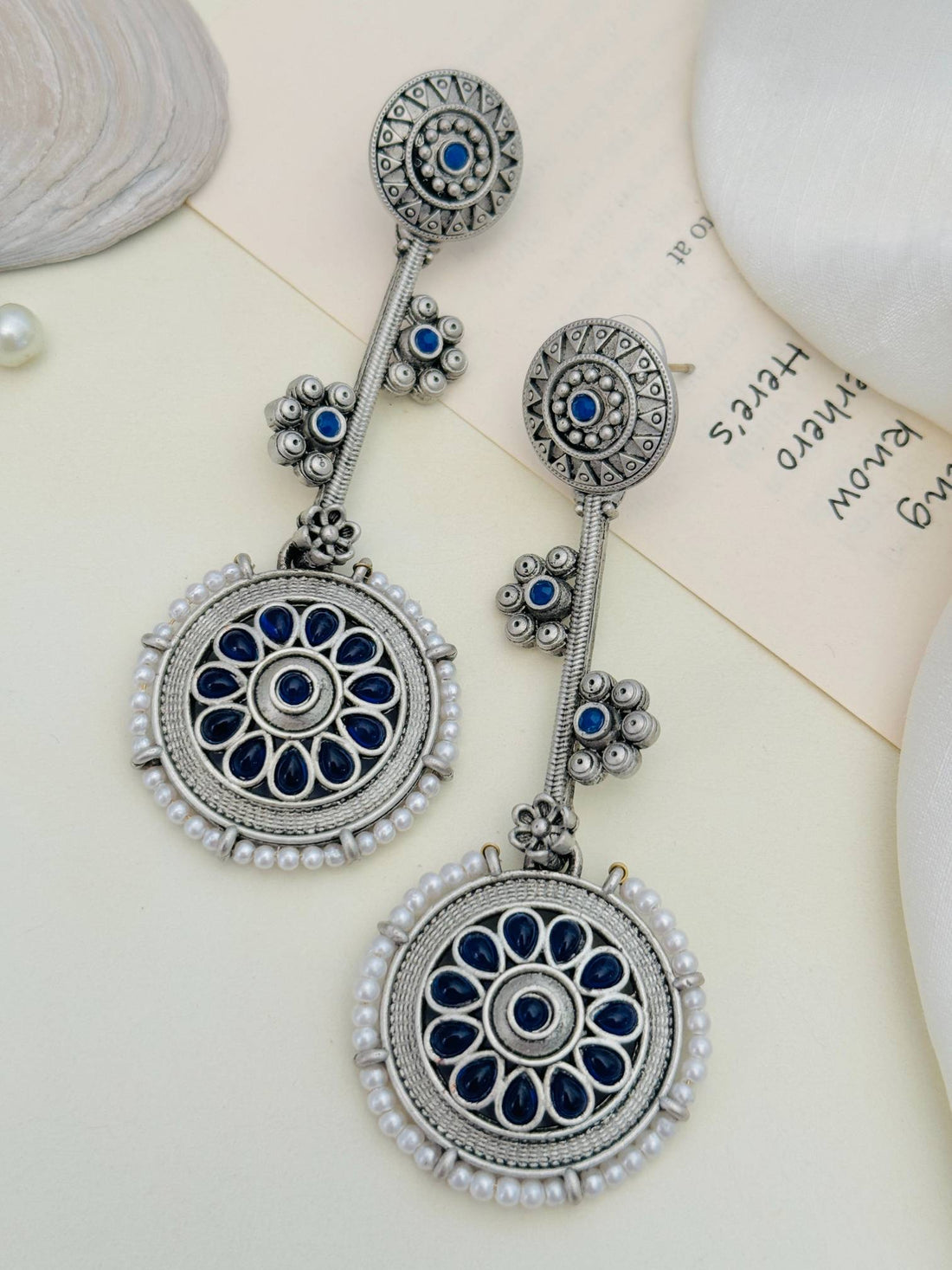 Contemporary German Silver Round Earring with intricate blue floral design worn by woman