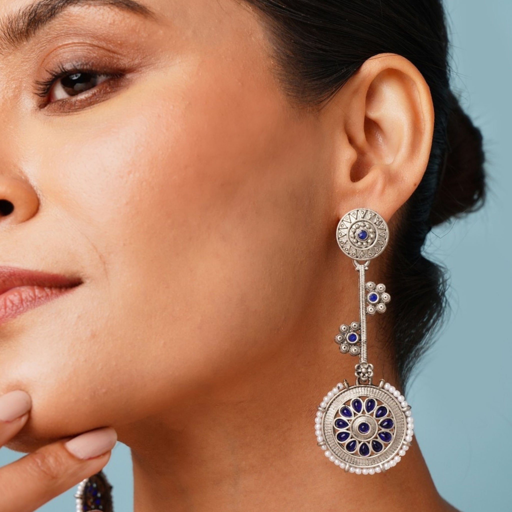 Contemporary German Silver Round Earring with intricate blue floral design worn by woman