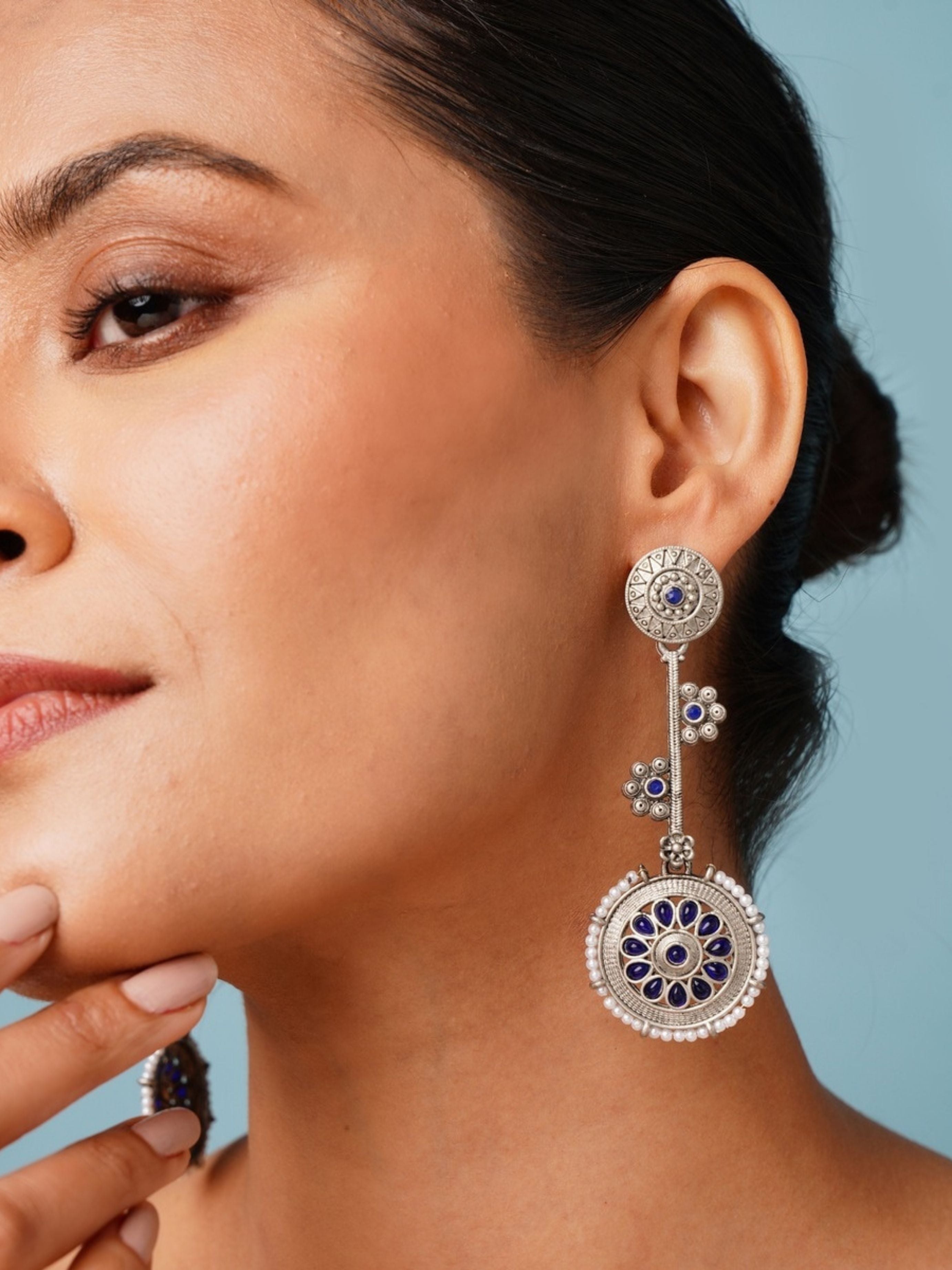 Contemporary German Silver Round Earring with intricate blue floral design worn by woman