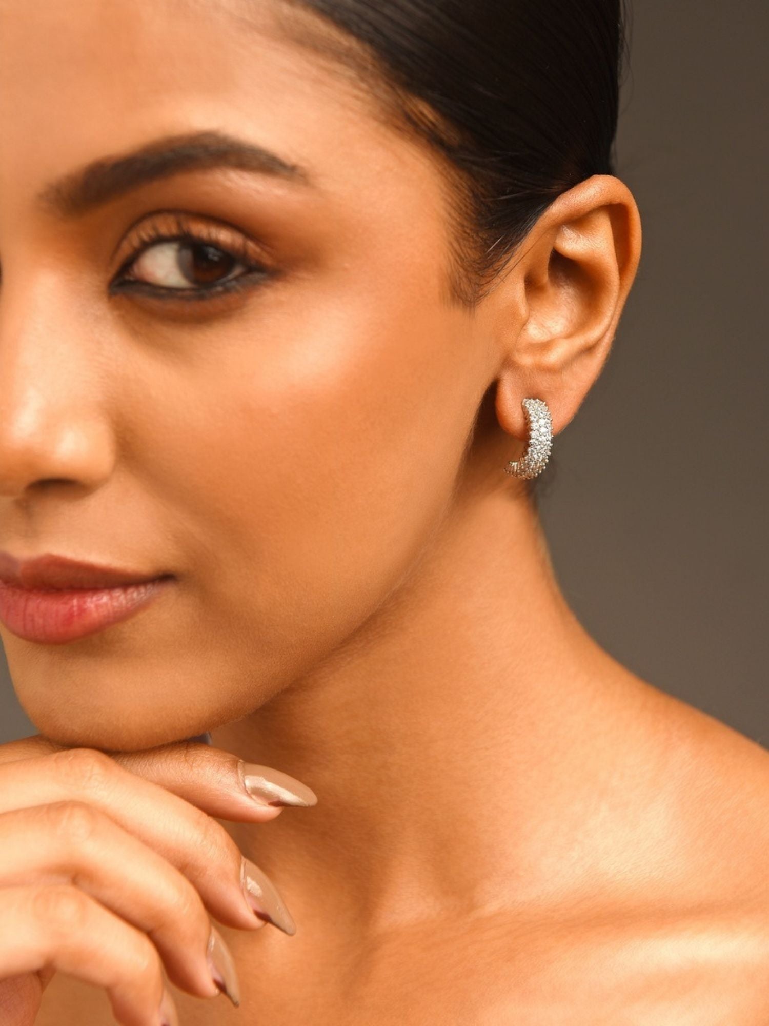 Delicate Silver Plated American Diamond Earring worn on a woman's ear by Abdesignsjewellery