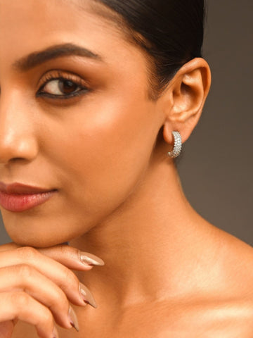 Delicate Silver Plated American Diamond Earring worn on a woman's ear by Abdesignsjewellery