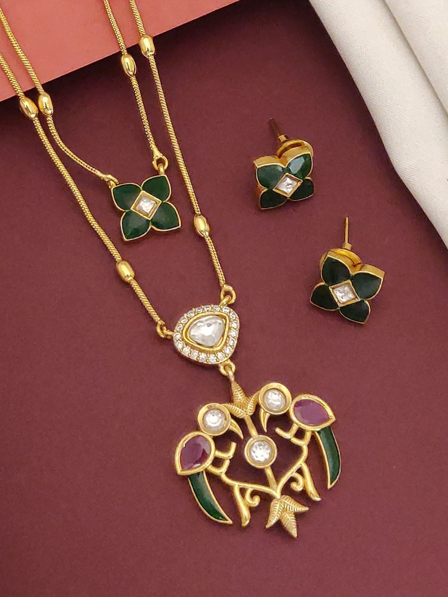 Double Layer paachi kundan imitation jewelry . Gold tone layered necklace with green enamel and matching floral stud earrings