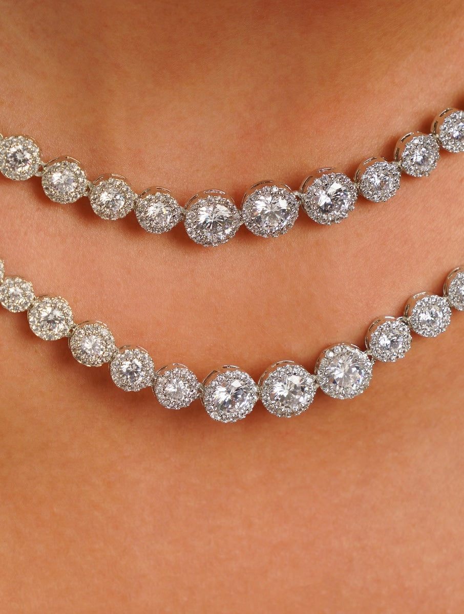 Abdesignsjewellery model wearing double layer silver necklace set with two tiers of round zirconia and long drop earrings