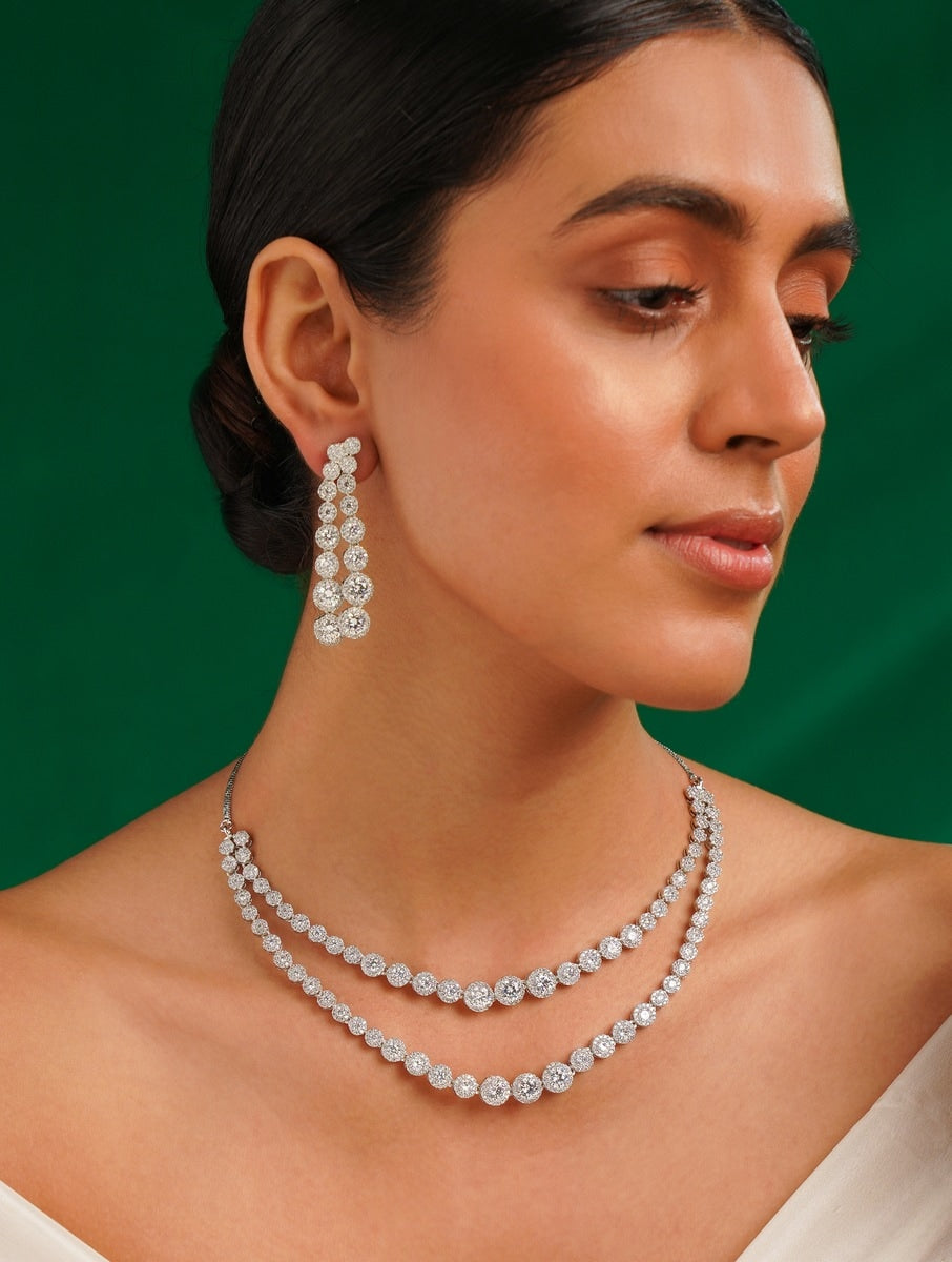 Abdesignsjewellery model wearing double layer silver necklace set with two tiers of round zirconia and long drop earrings