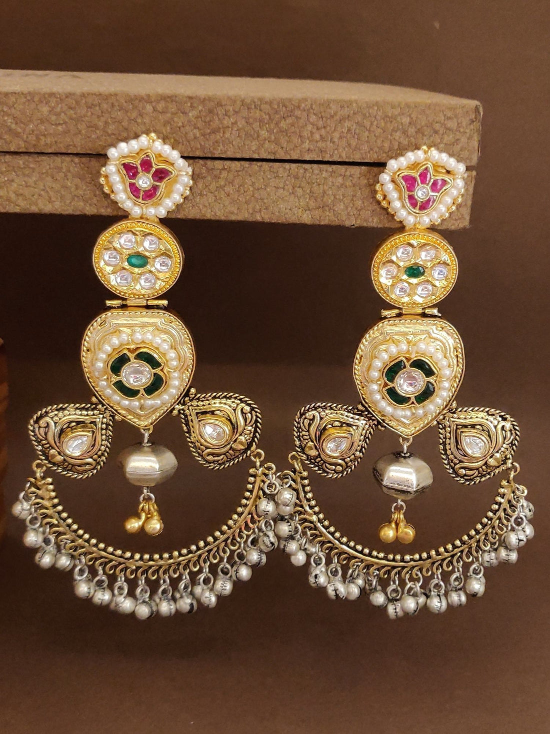 Abdesignsjewellery dual tone Chandbali earrings with intricate design and colorful stones worn on ear