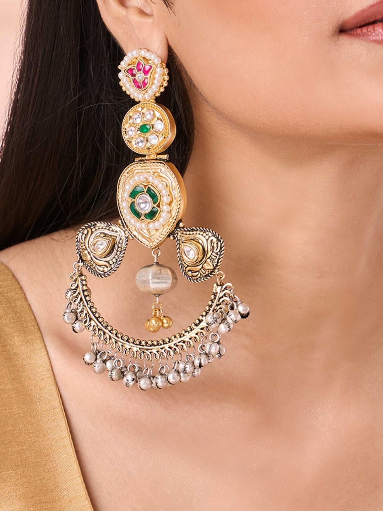 Abdesignsjewellery dual tone Chandbali earrings with intricate design and colorful stones worn on ear
