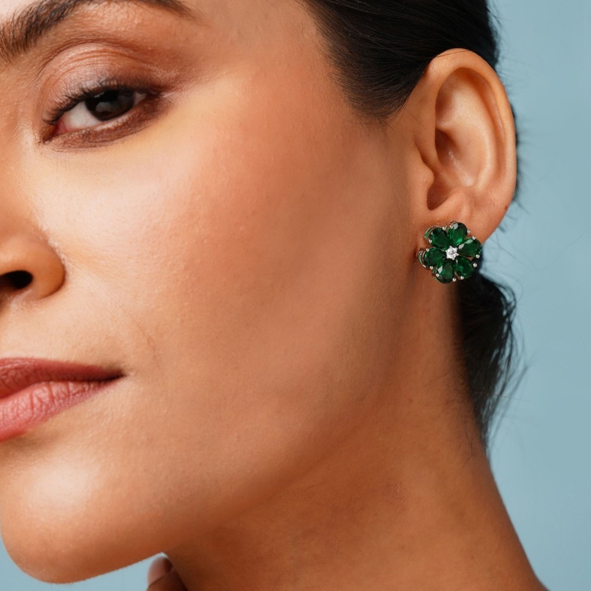 Elegant Green Stone Earrings By Abdesigns Jewellery. Close up on model wearing green floral stone stud earrings