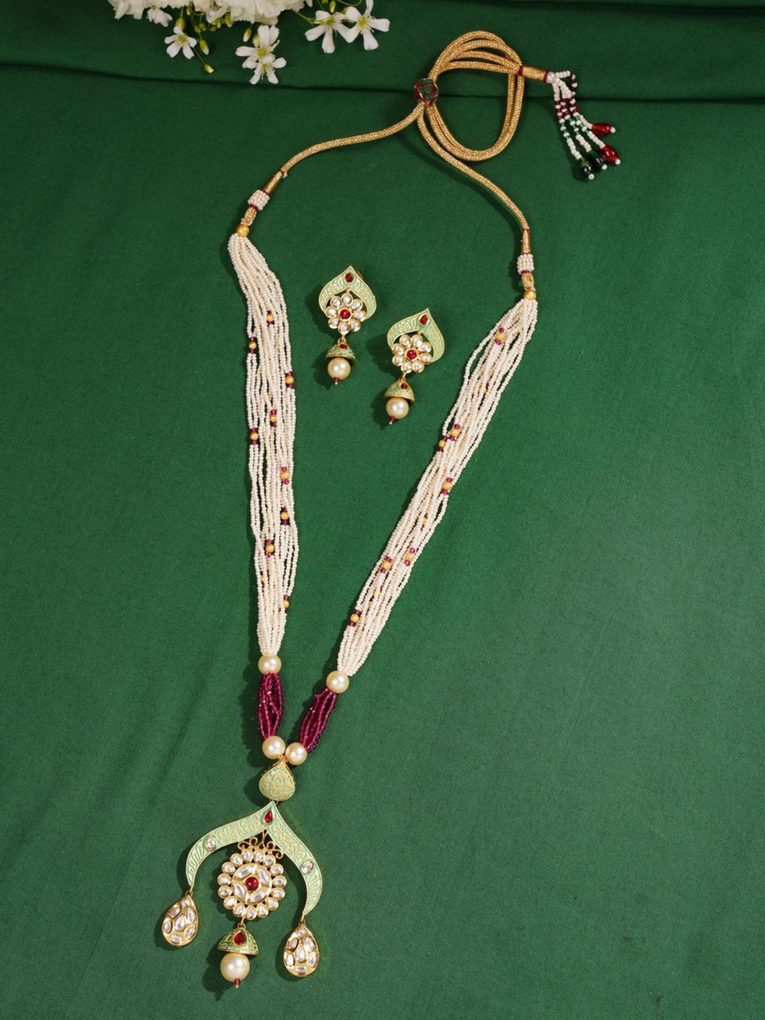 Elegant High Quality Kundan Necklace Set worn by woman with matching gold earrings and white outfit