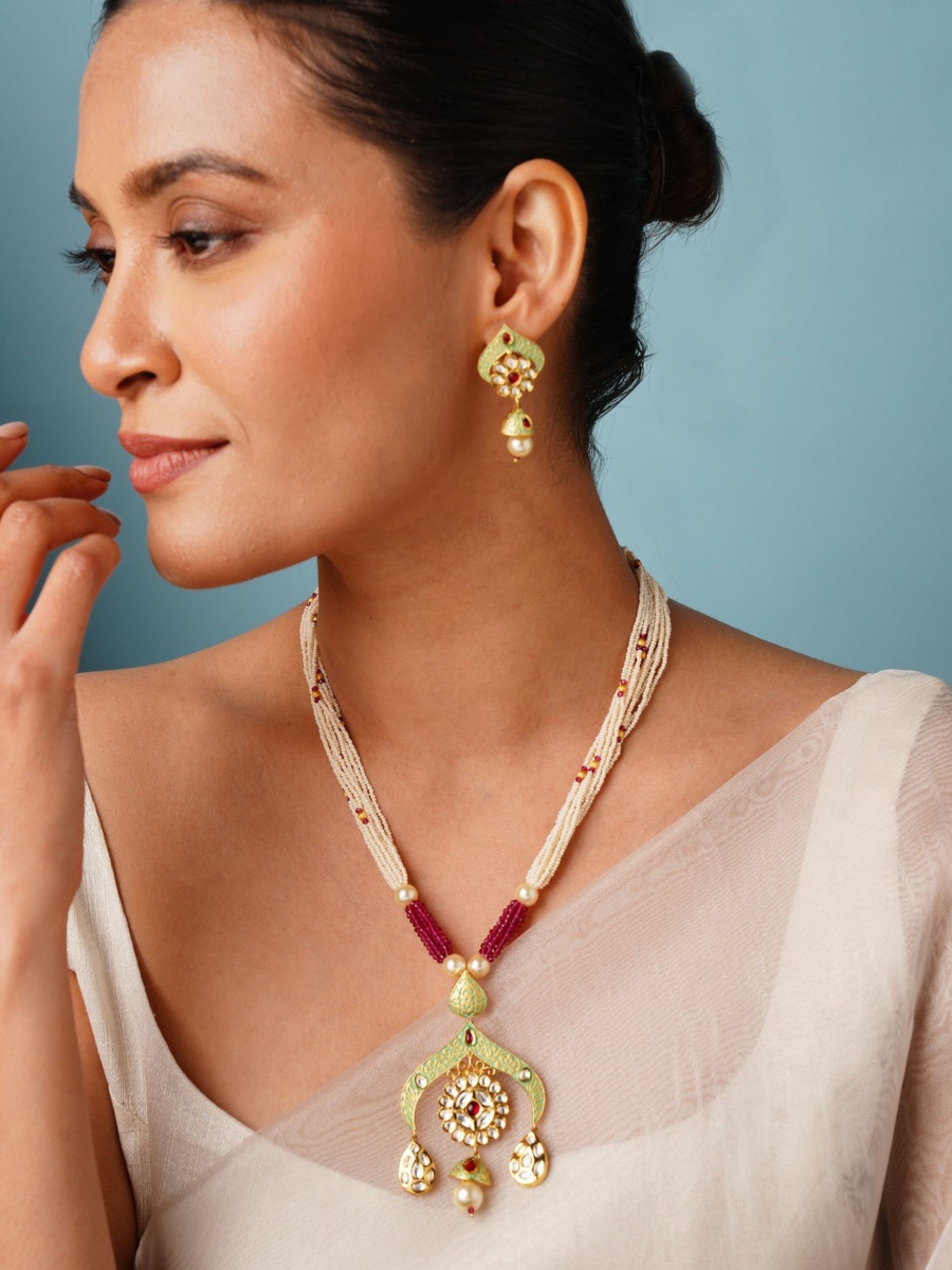 Elegant High Quality Kundan Necklace Set worn by woman with matching gold earrings and white outfit