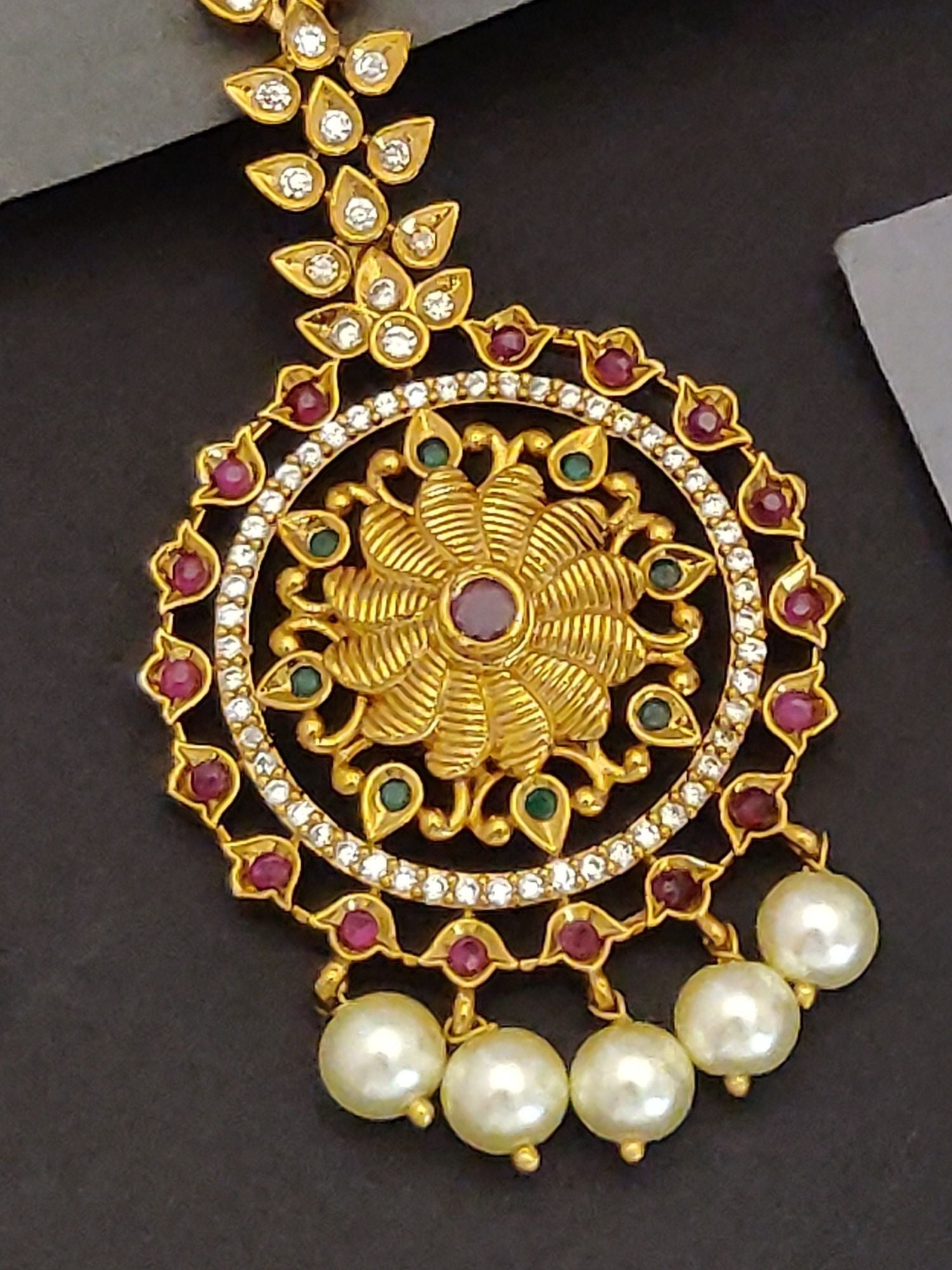 Elegant Indian bridal maangtikka by Abdesignsjewellery gold floral pendant with ruby and emerald accents and dangling pearls