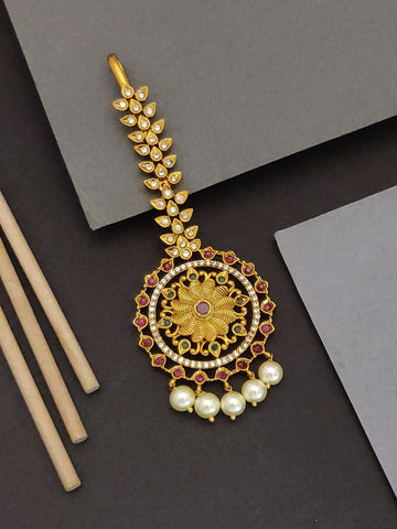 Elegant Indian bridal maangtikka from Abdesignsjewellery gold floral pendant with pearls and red stones