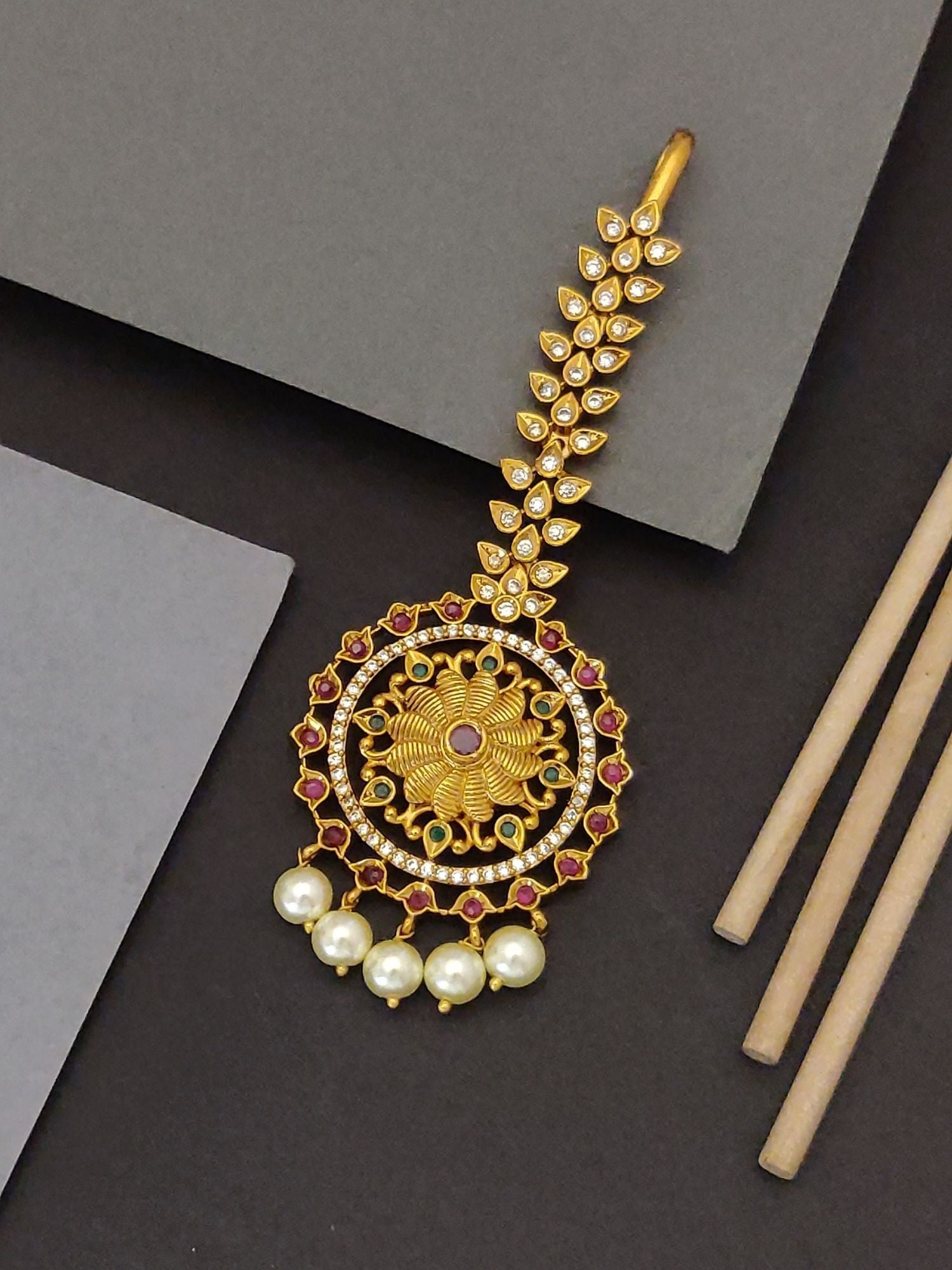 Elegant Indian bridal maangtikka by Abdesignsjewellery gold floral pendant with kundan stones red accents and hanging pearls