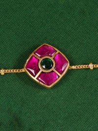Thumbnail for Close-up of Enchanting Gold Plated Kemp Kundan Floral Anklets with pink and green stones on a green fabric background