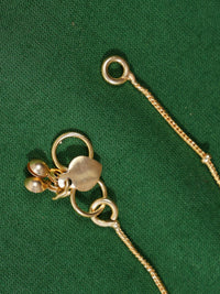 Thumbnail for Close-up of Enchanting Gold Plated Kemp Kundan Floral Anklets chain and clasp on green fabric