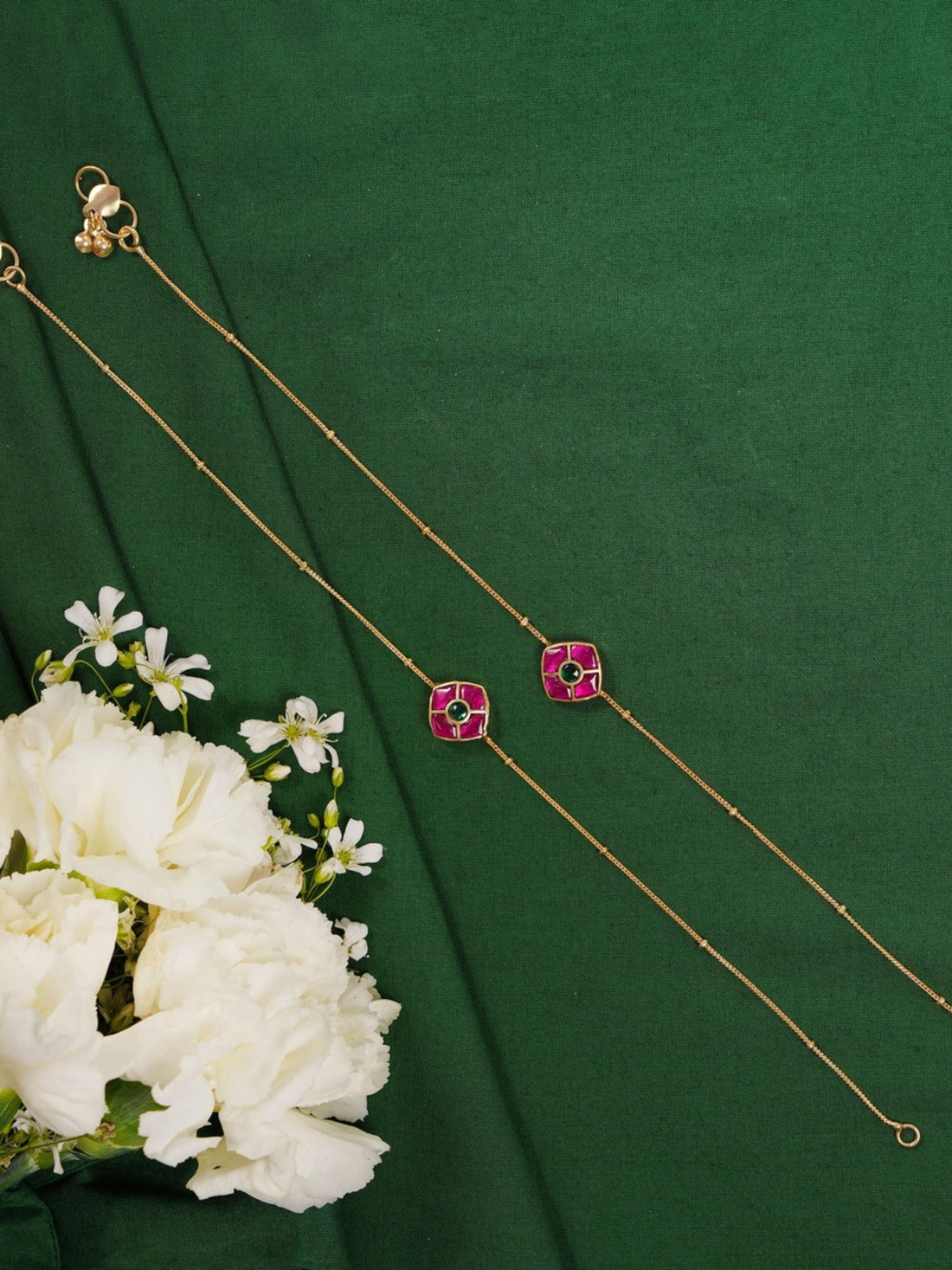 Enchanting Gold Plated Kemp Kundan Floral Anklets on feet with delicate chain and pink floral design