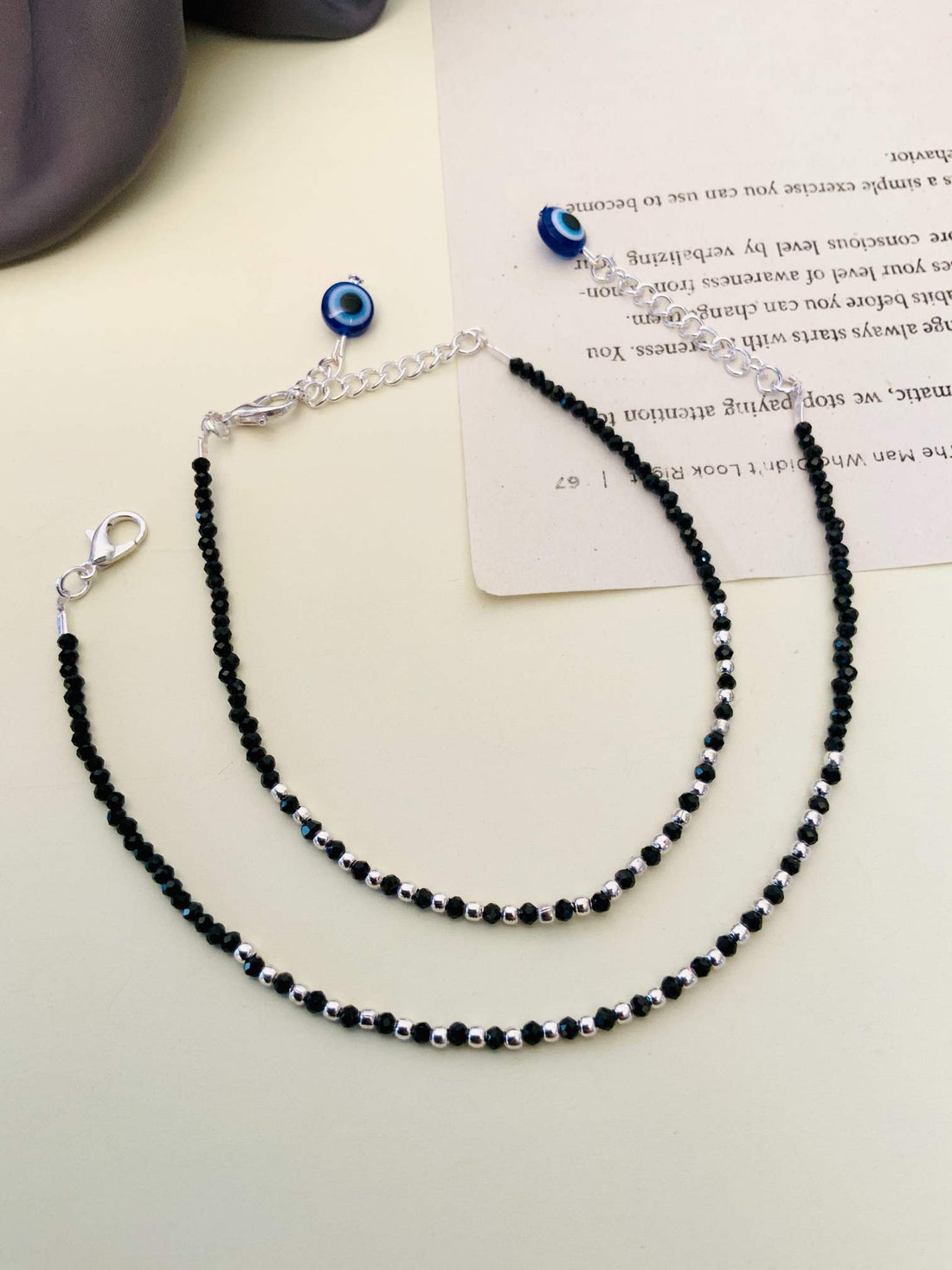 Eye Catching Silver Plated Evil Eye Anklet worn on ankle with black and silver bead design