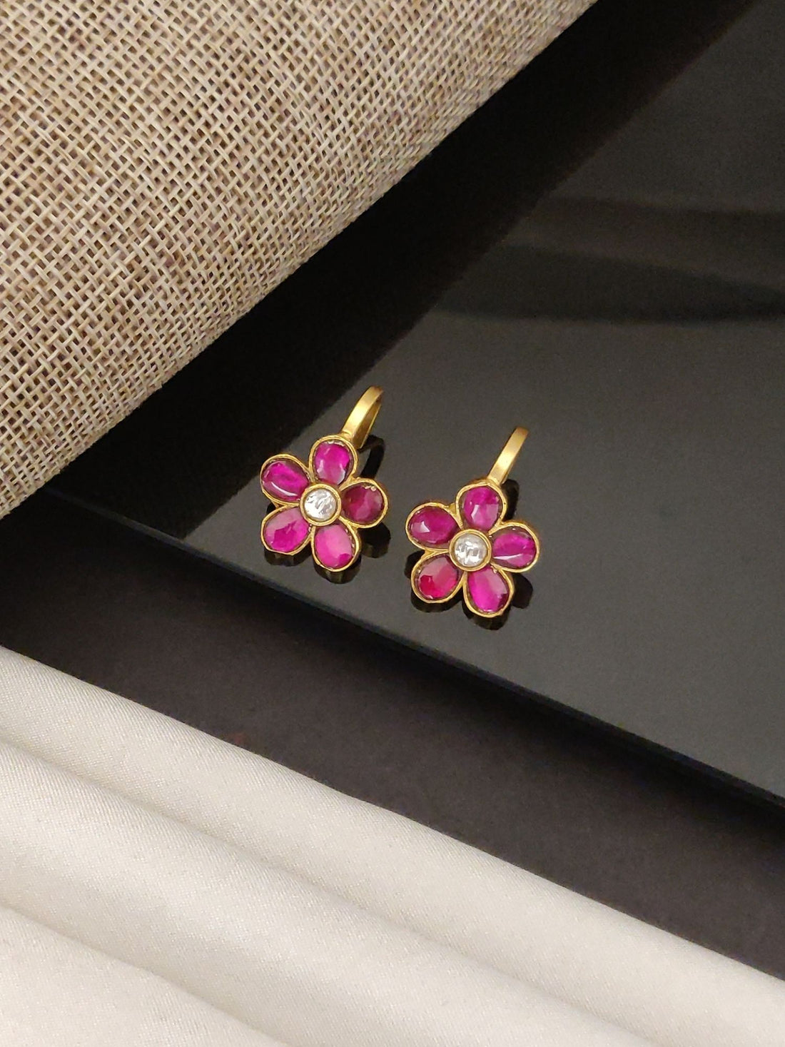 Festive artificial bugdi earring pair gold floral design with pink enamel petals and central crystal