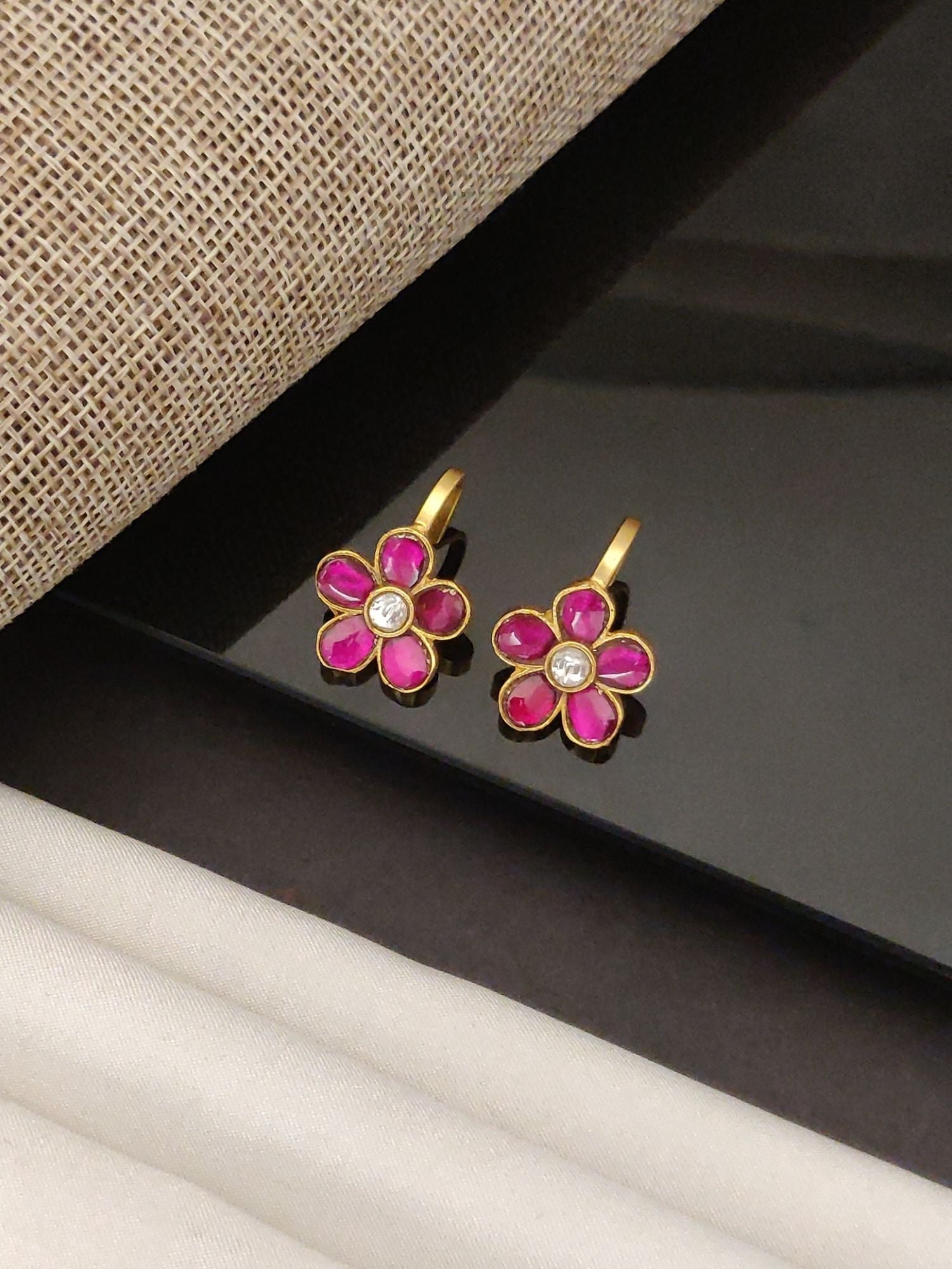 Festive artificial bugdi earring pink enamel flower pair with gold finish and central clear stone for ethnic wear