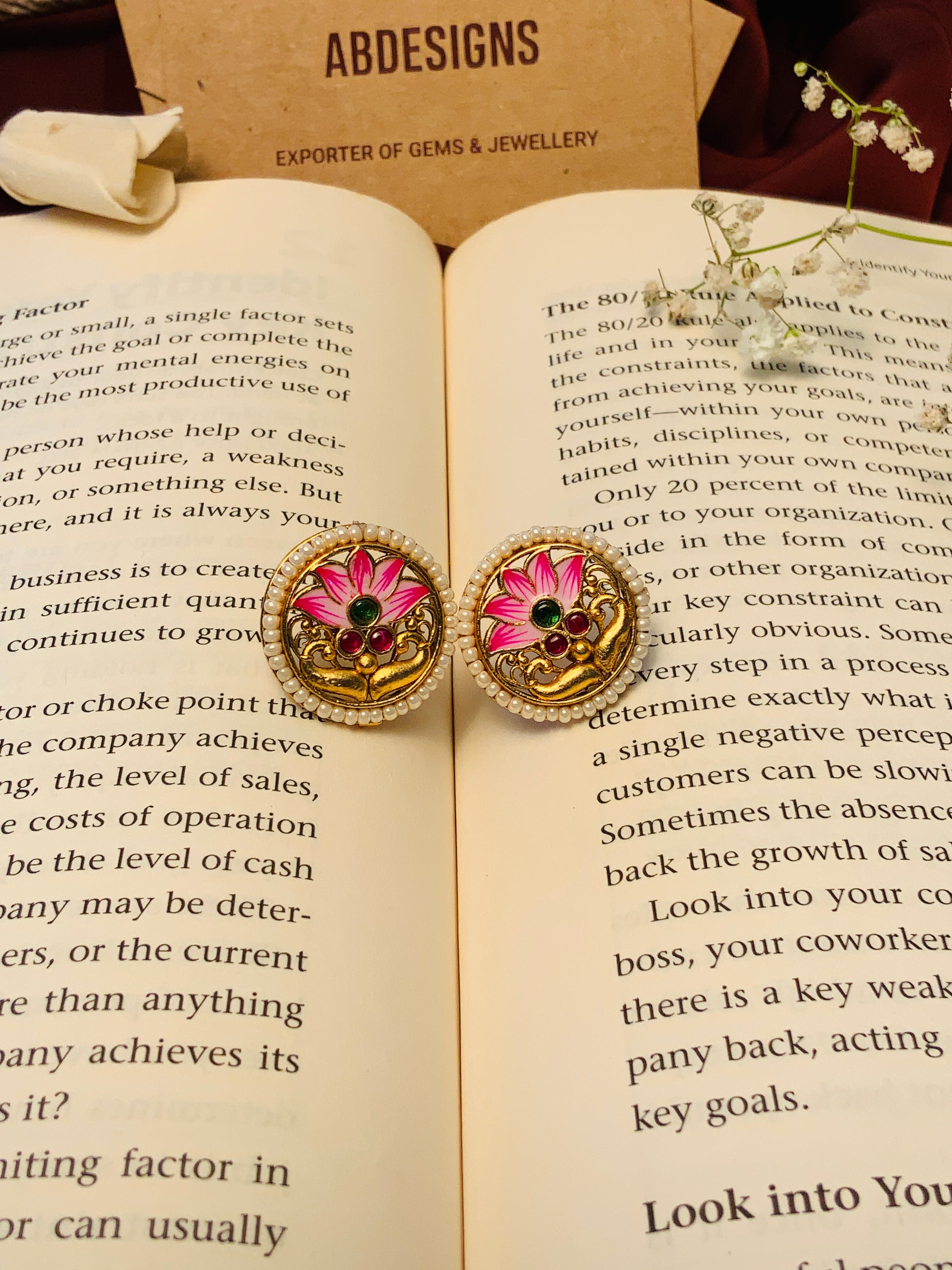 Floral Antique Gold Plated Necklace Set with pink flower design by Abdesignsjewellery on an open book