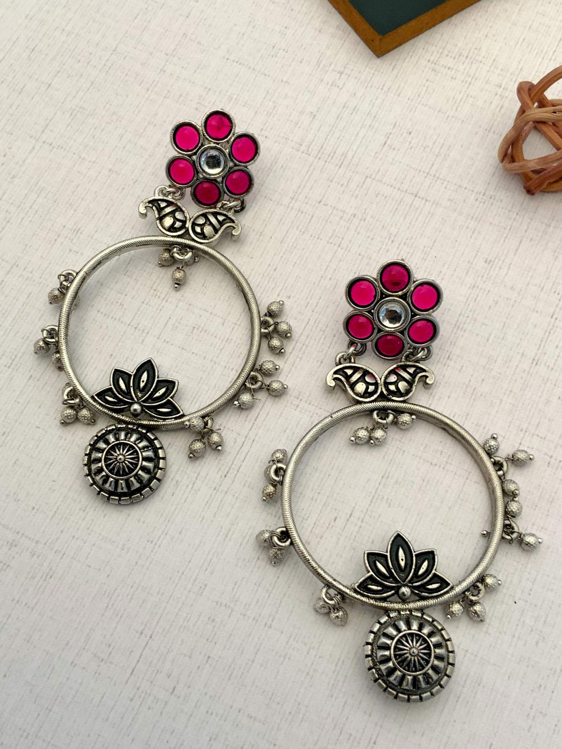 Abdesignsjewellery German Silver Plated Floral Earring with red accents worn on model's ear